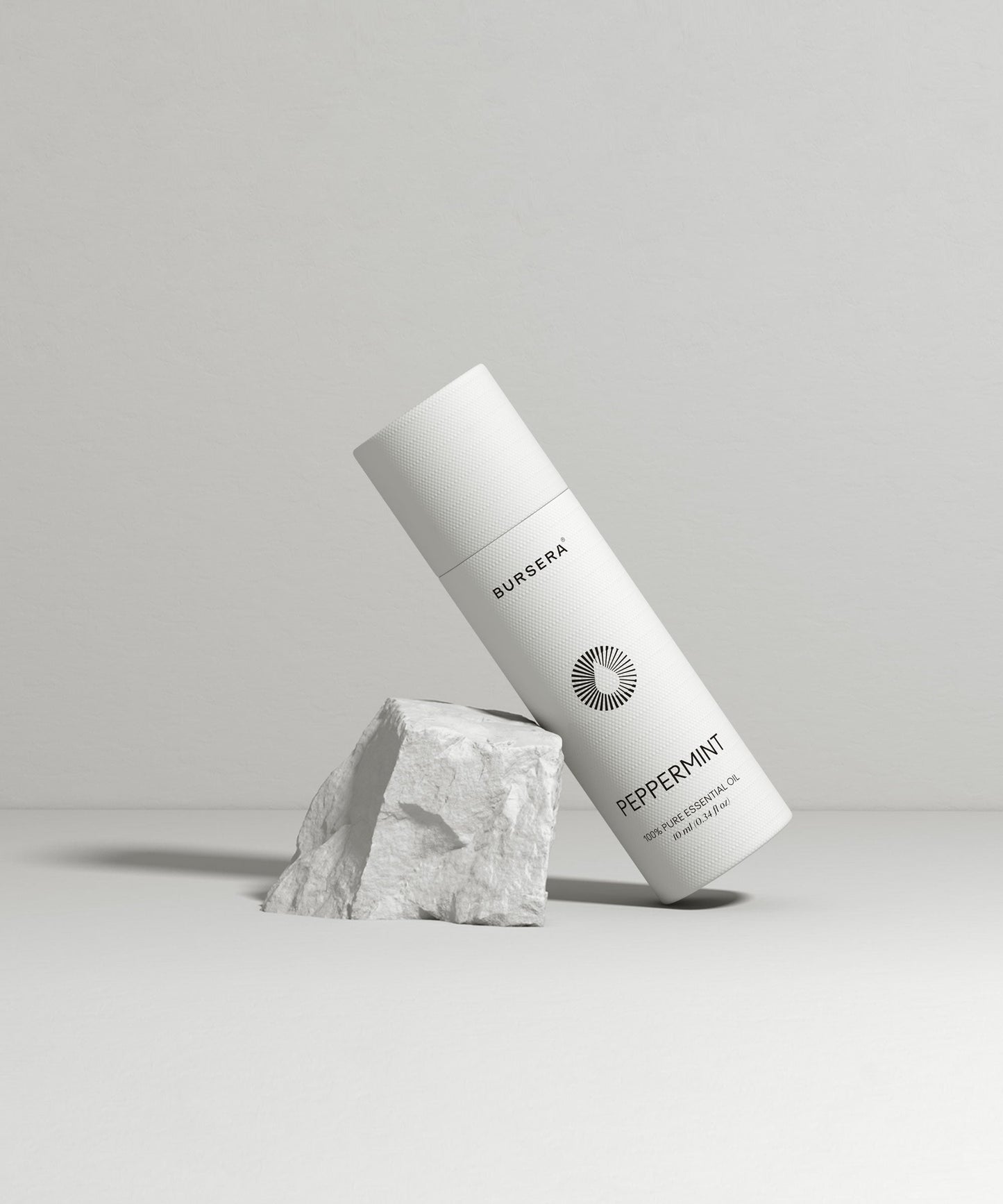 organic peppermint essential oil aromatherapy with branding on a light gray background