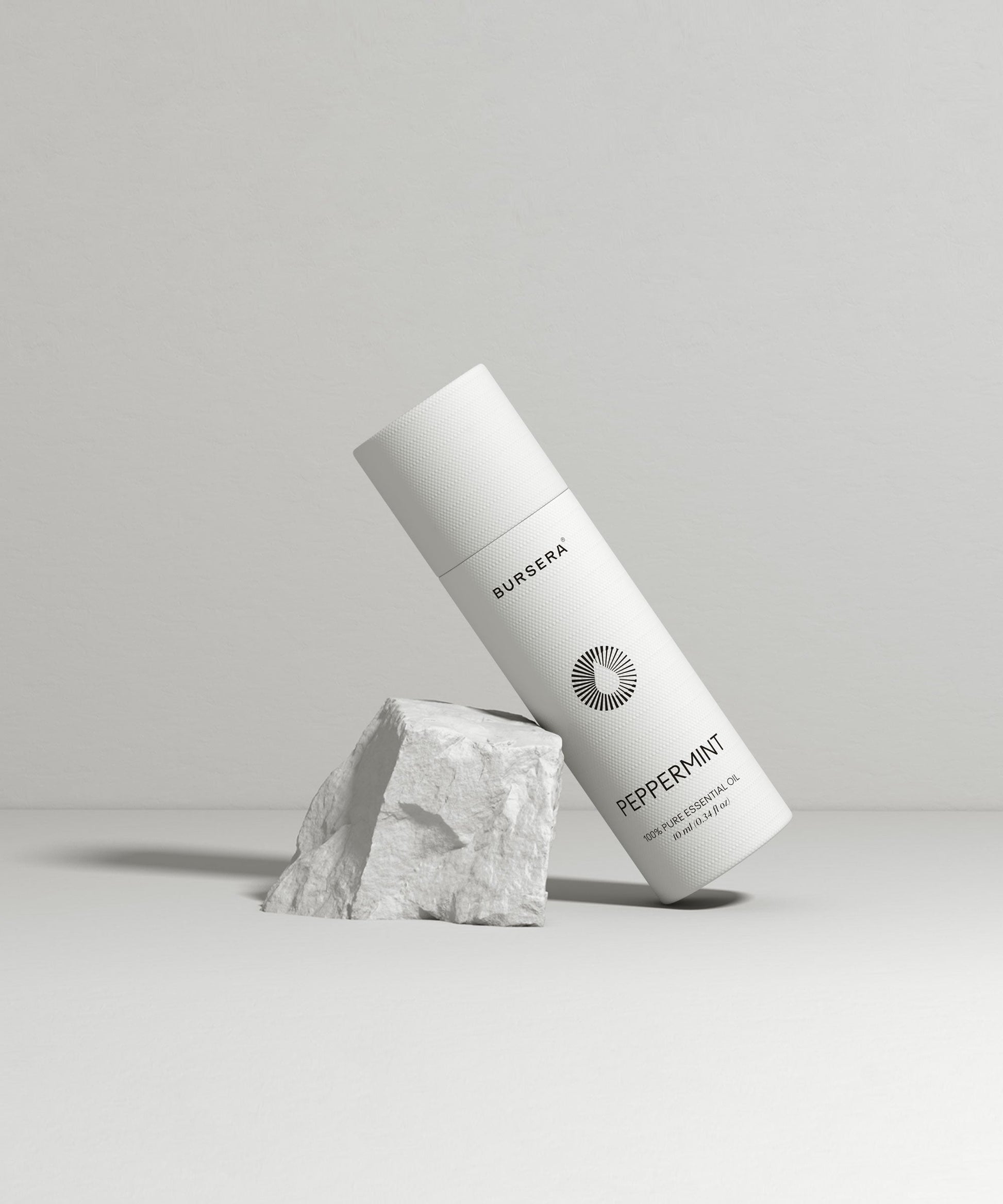 organic peppermint essential oil aromatherapy with branding on a light gray background
