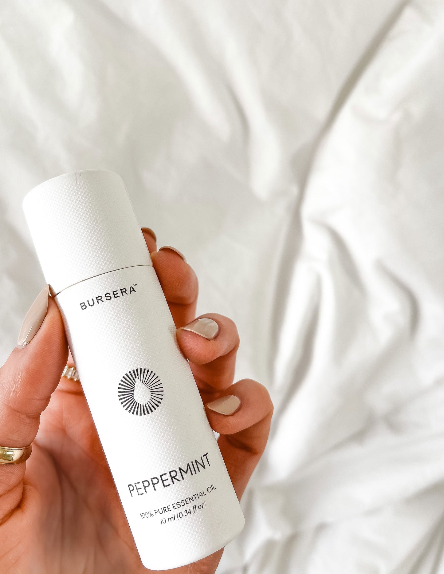 organic peppermint essential oil aromatherapy oil bottle against a white background