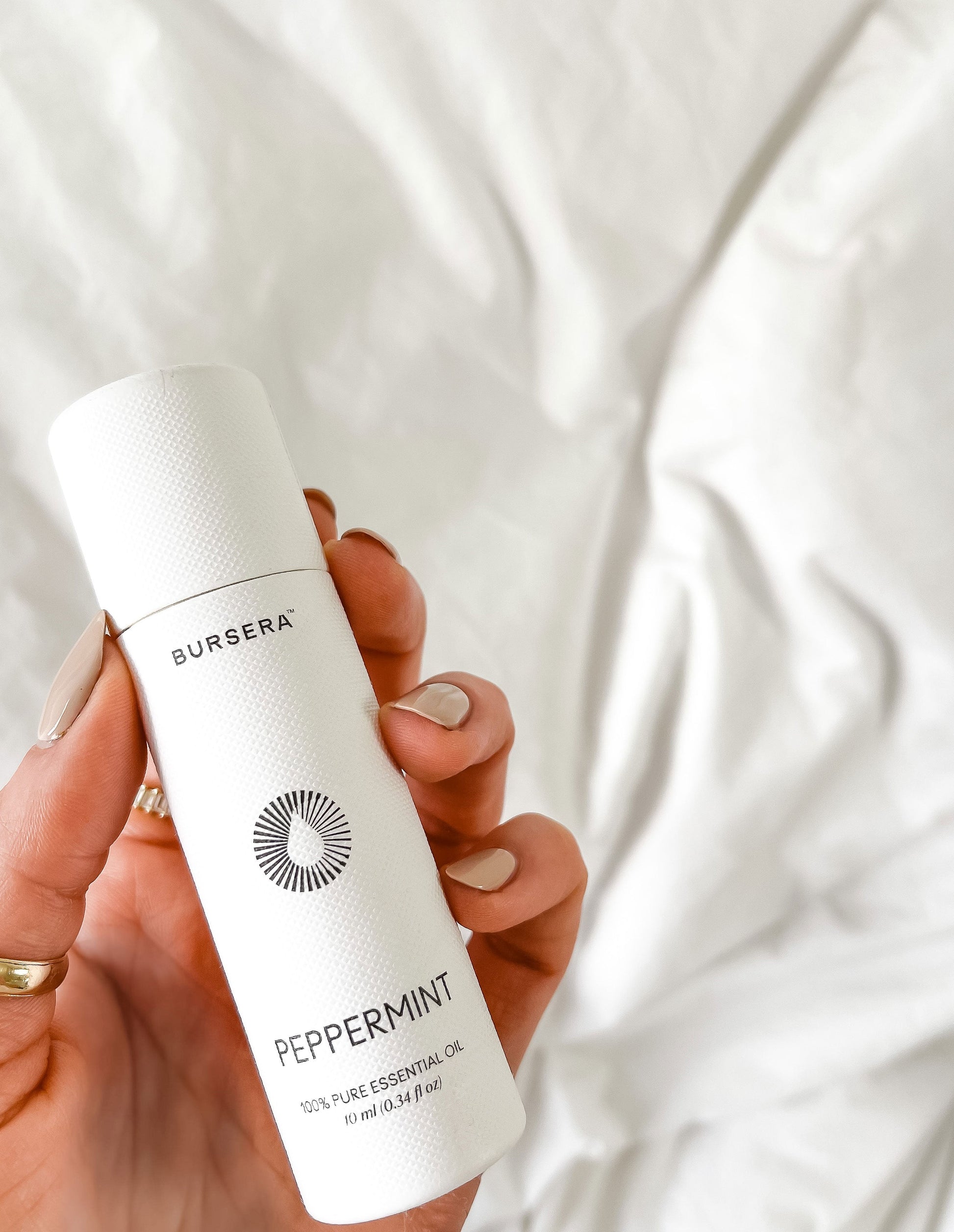 organic peppermint essential oil aromatherapy oil bottle against a white background