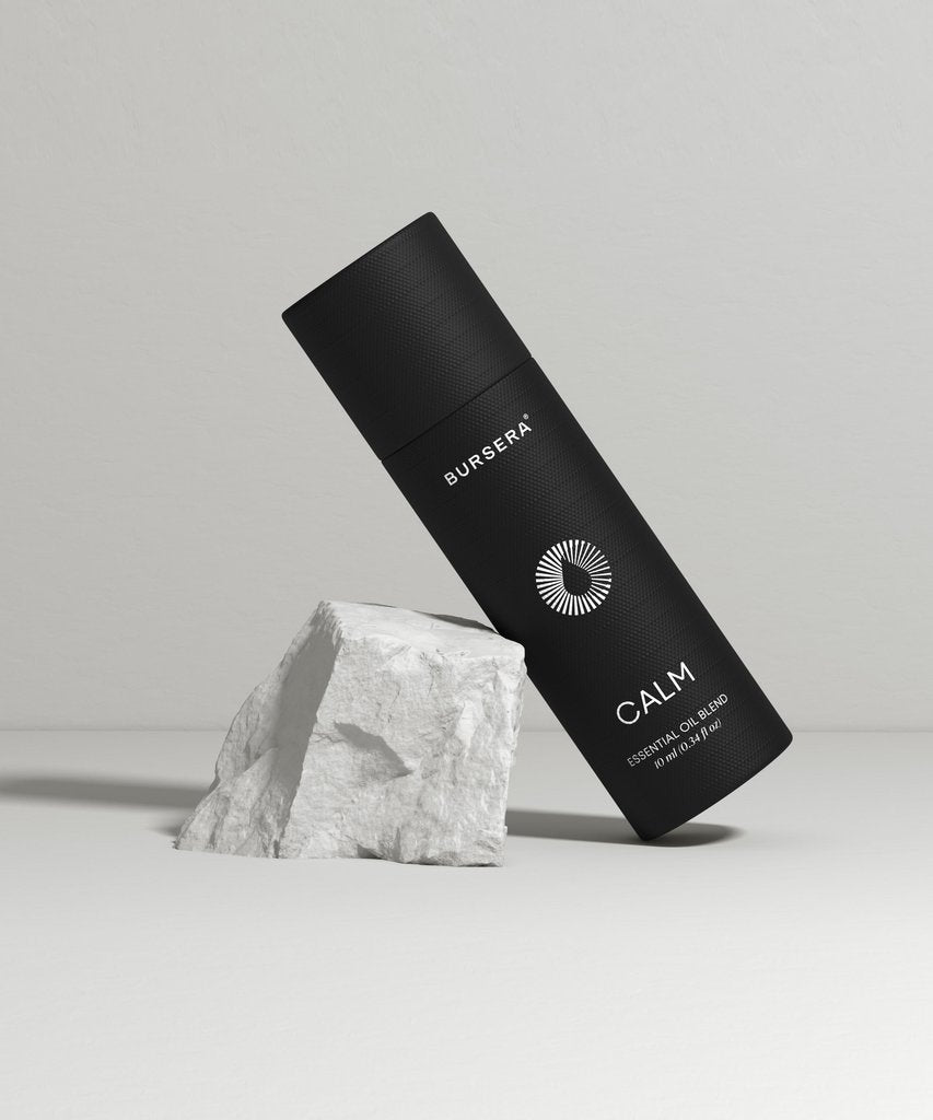 calm essential oil blend aromatherapy with 'Bursera' branding on a gray background