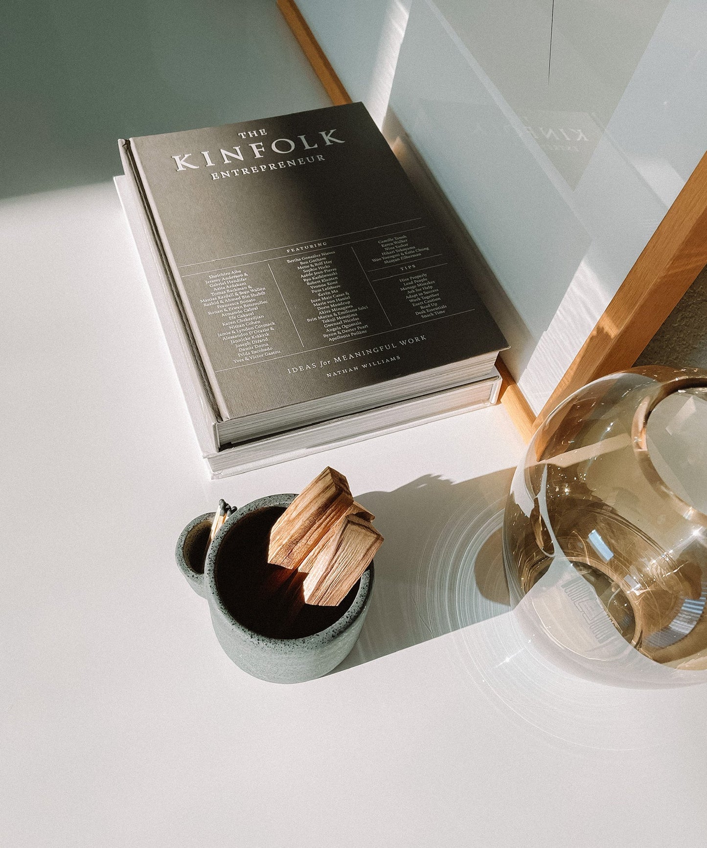 Vulcan ceramic bowl incense stick holder on a surface with a mug and decorative item.