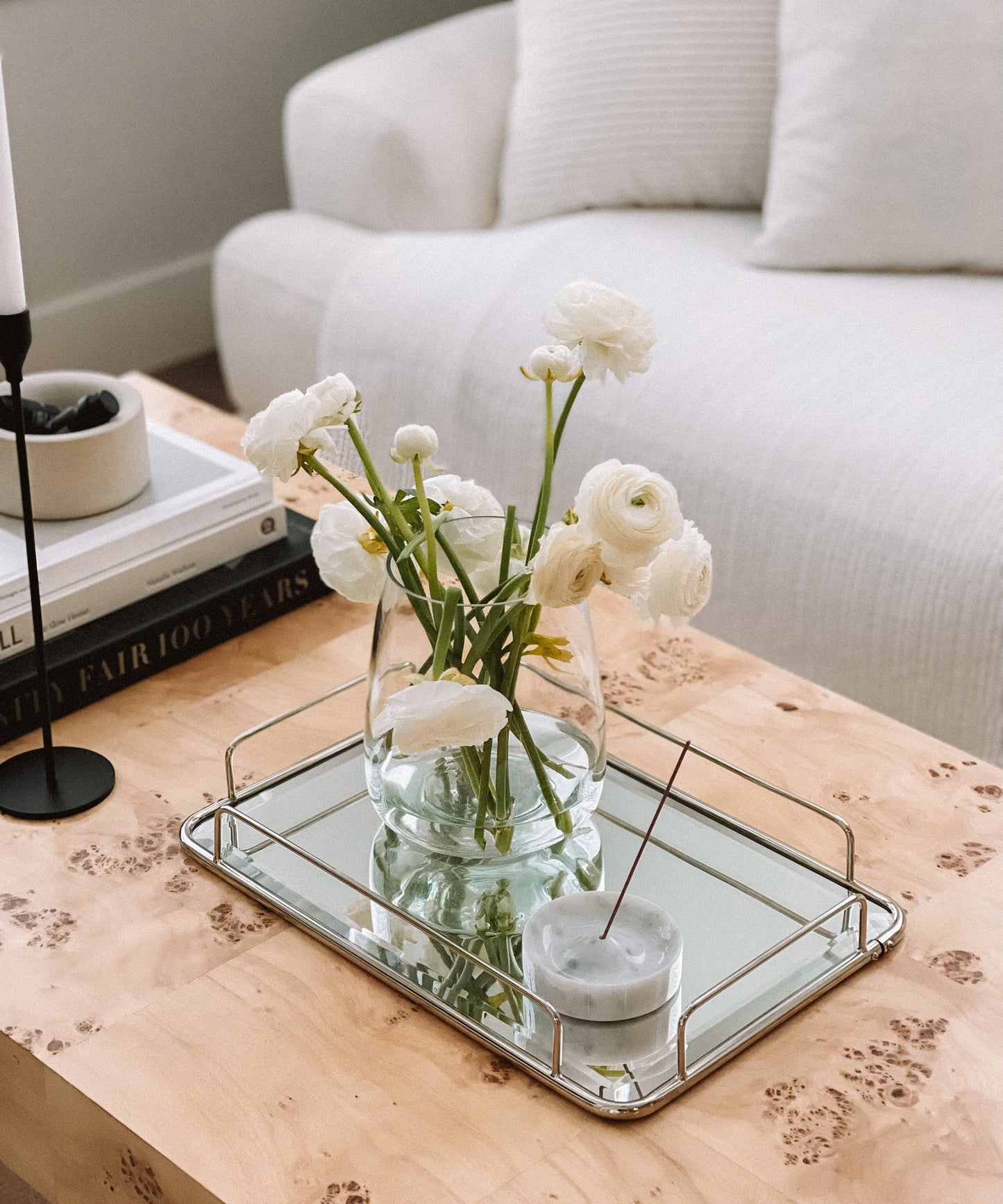white marble incense holder aromatherapy decor with white flowers on a mirrored tray