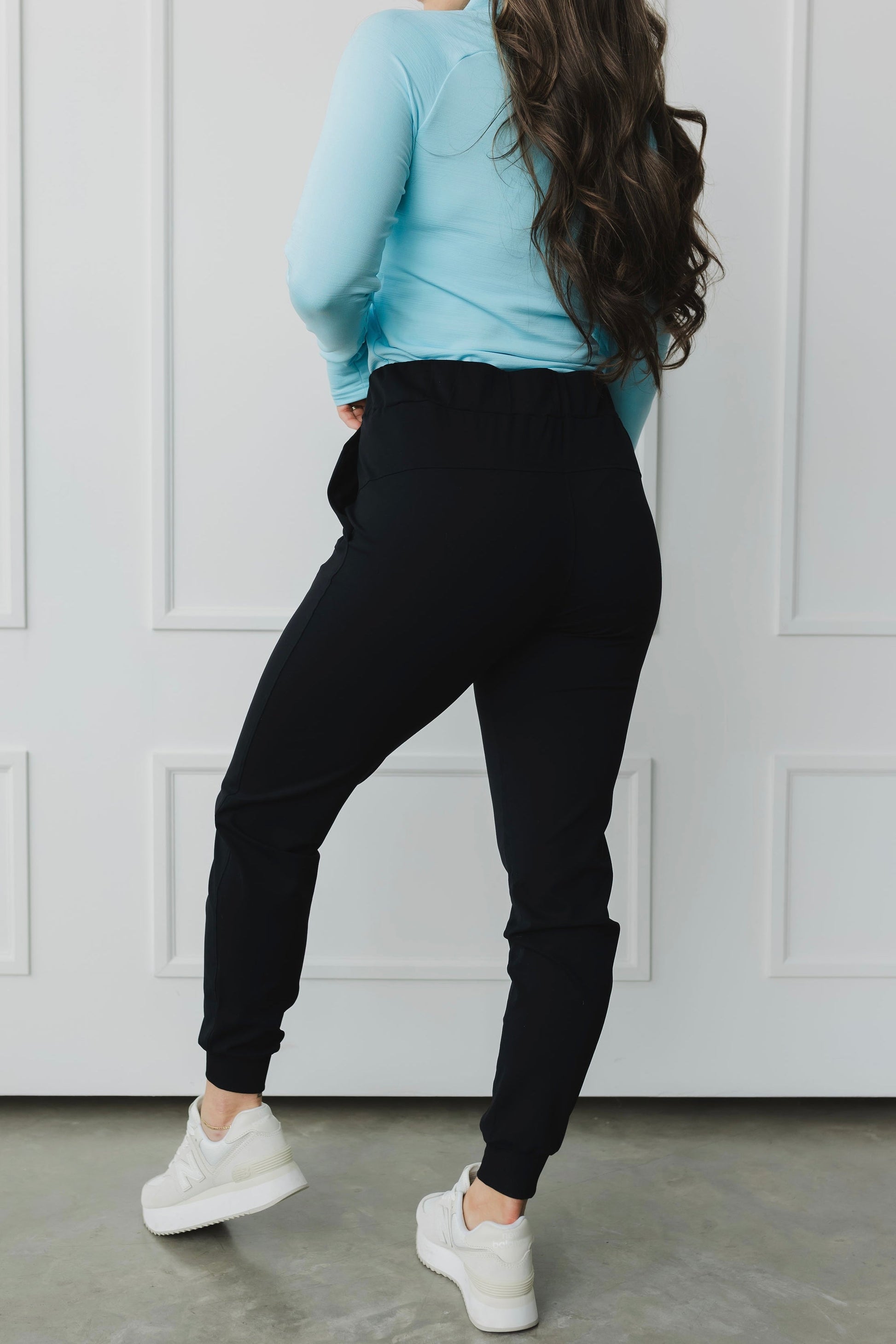 back view of a woman wearing cuffed ankle jogger in black for loungewear and casual athleisure 