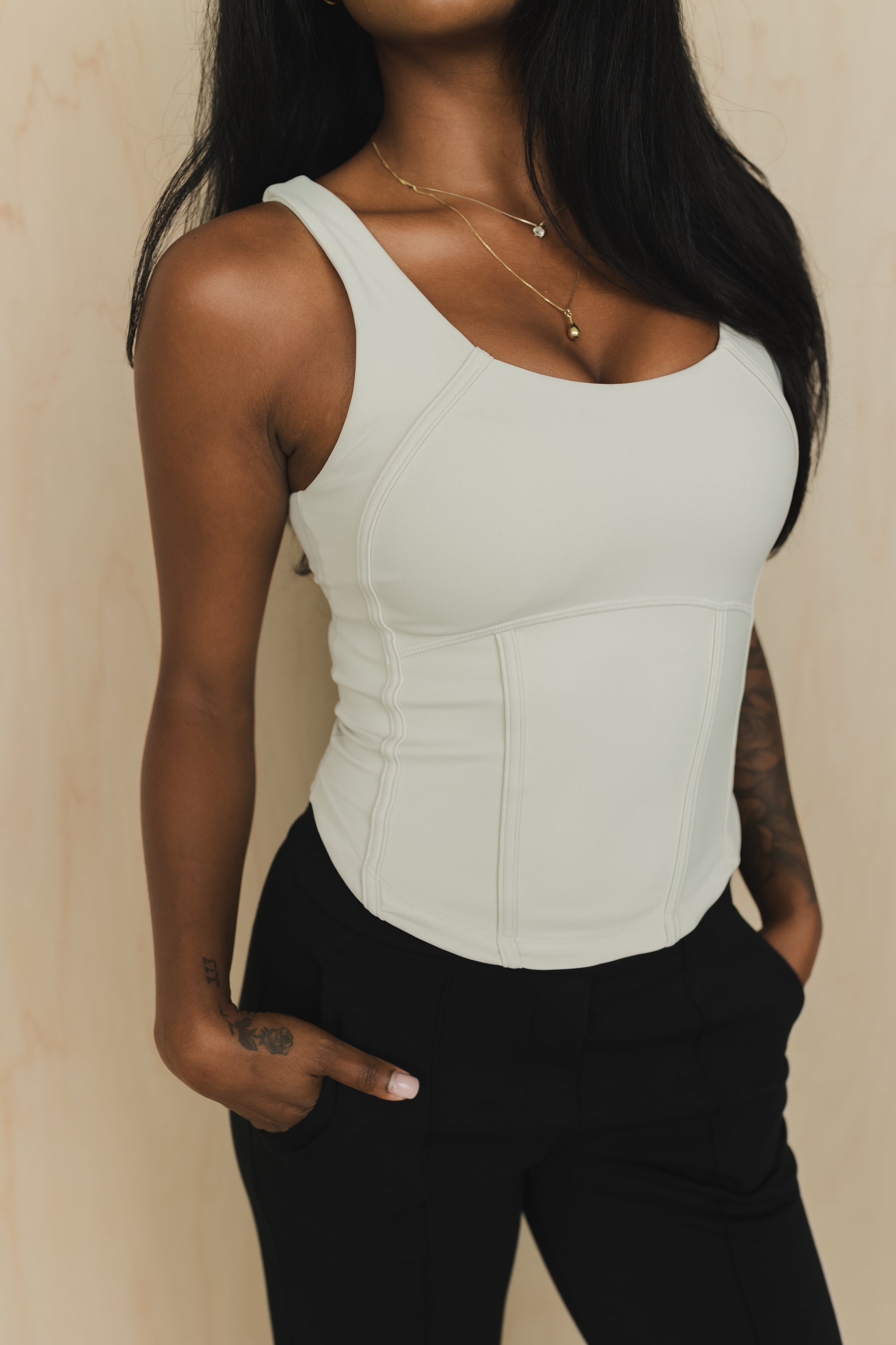close up view of a woman wearing a soft corset waist cincher in bone white for casual wear