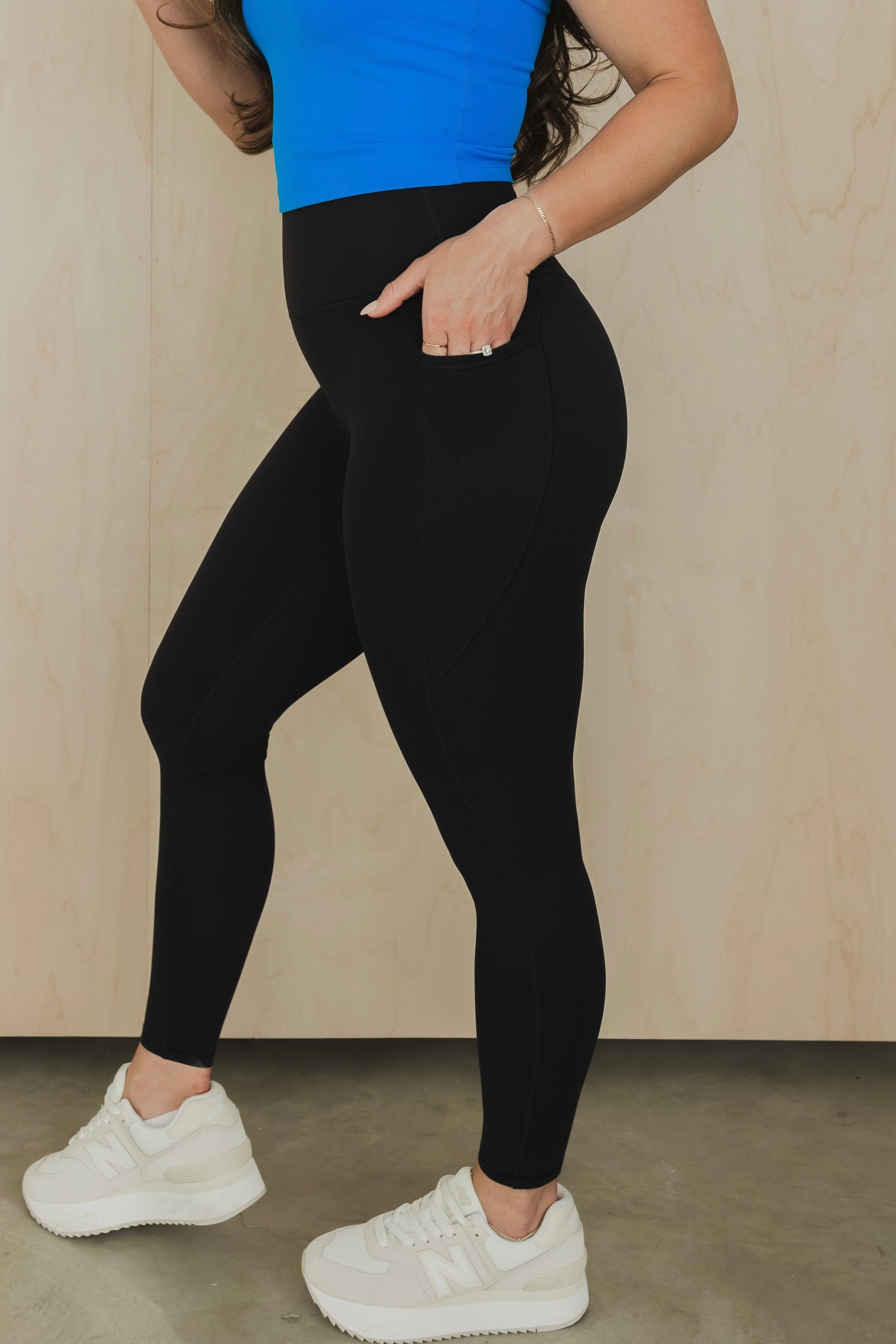 side view of a woman wearing the unmatched pant in black for the gym and everyday activewear