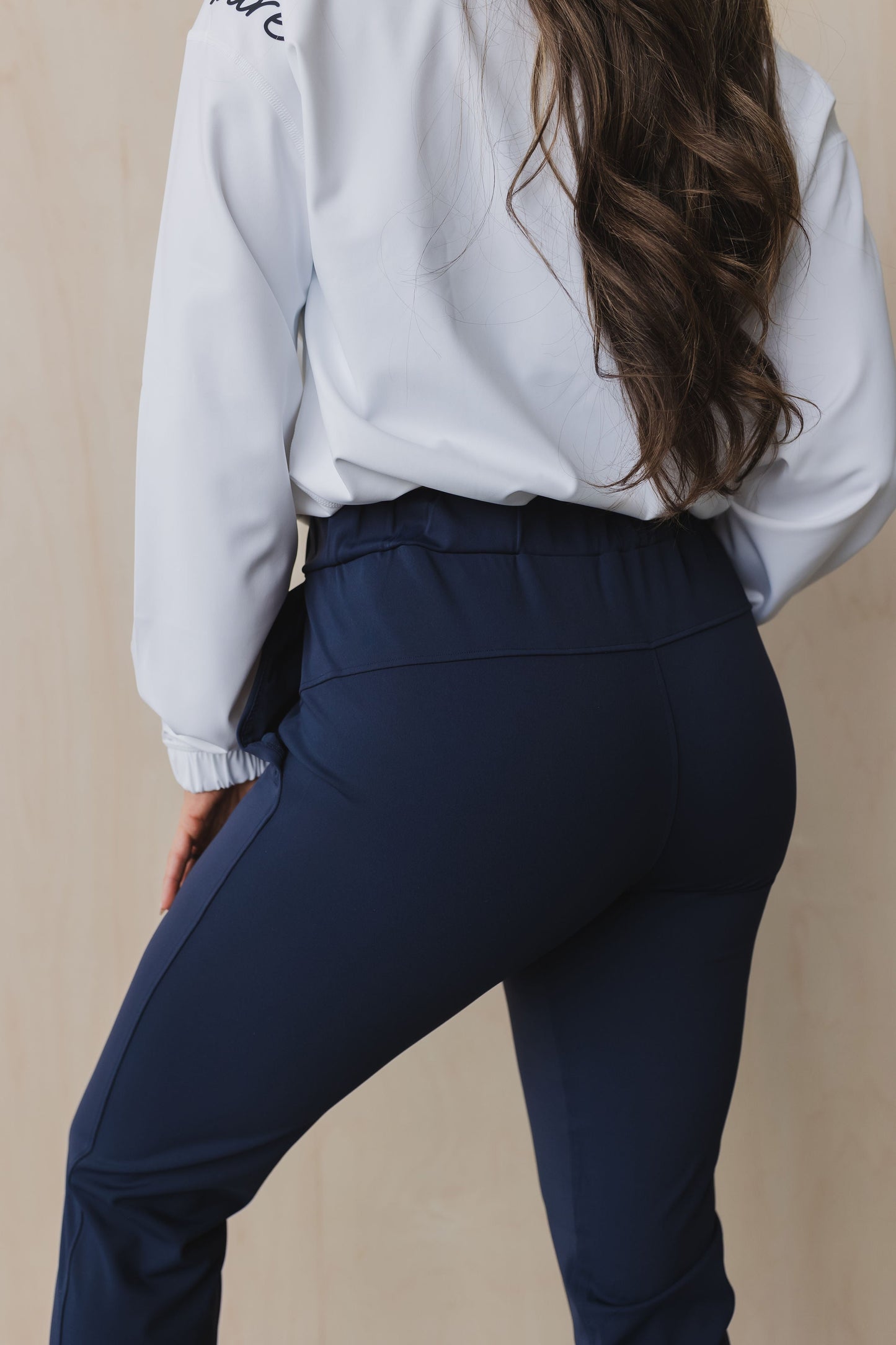back view of a woman wearing cuffed ankle jogger in indigo for workouts and casual wear