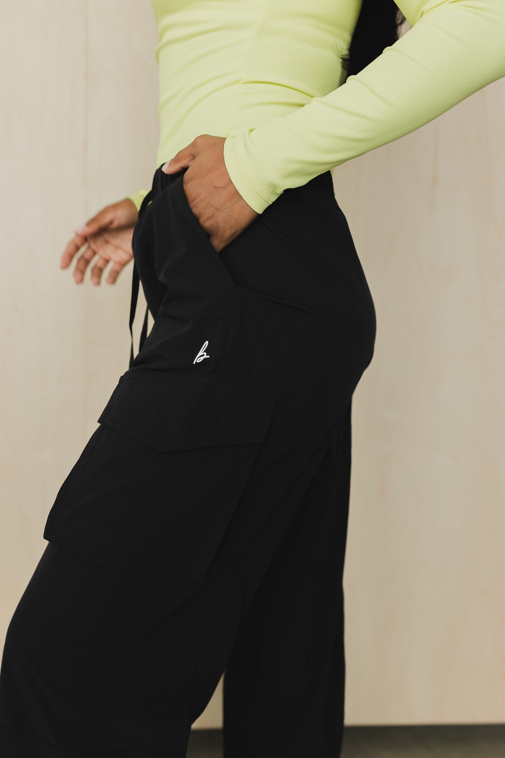 zoomed in pocket view of a woman wearing cargo pant in black for streetwear and versatile everyday styling