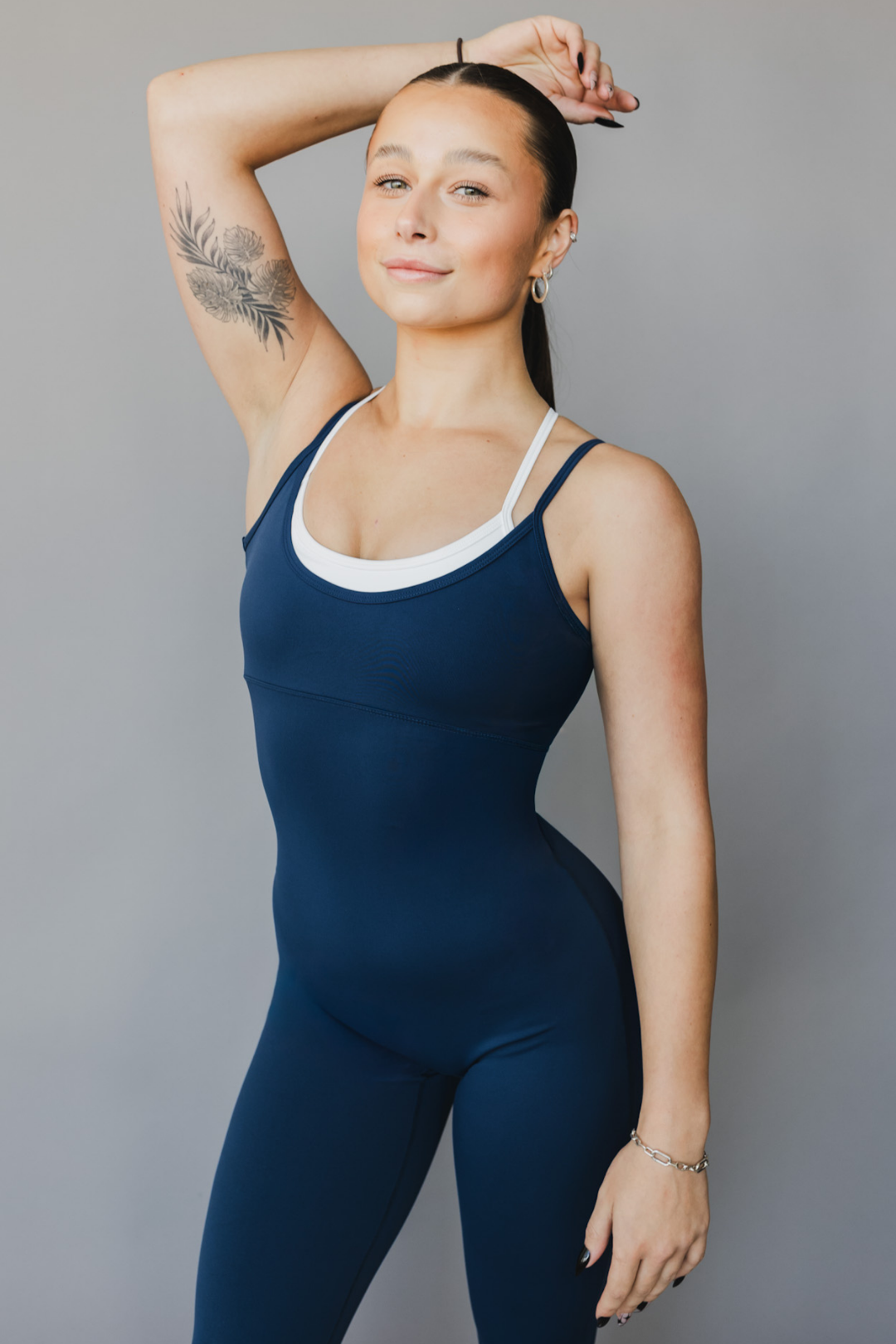 front close up view of a woman wearing tina bodysuit in winter blue for the gym and versatile activewear