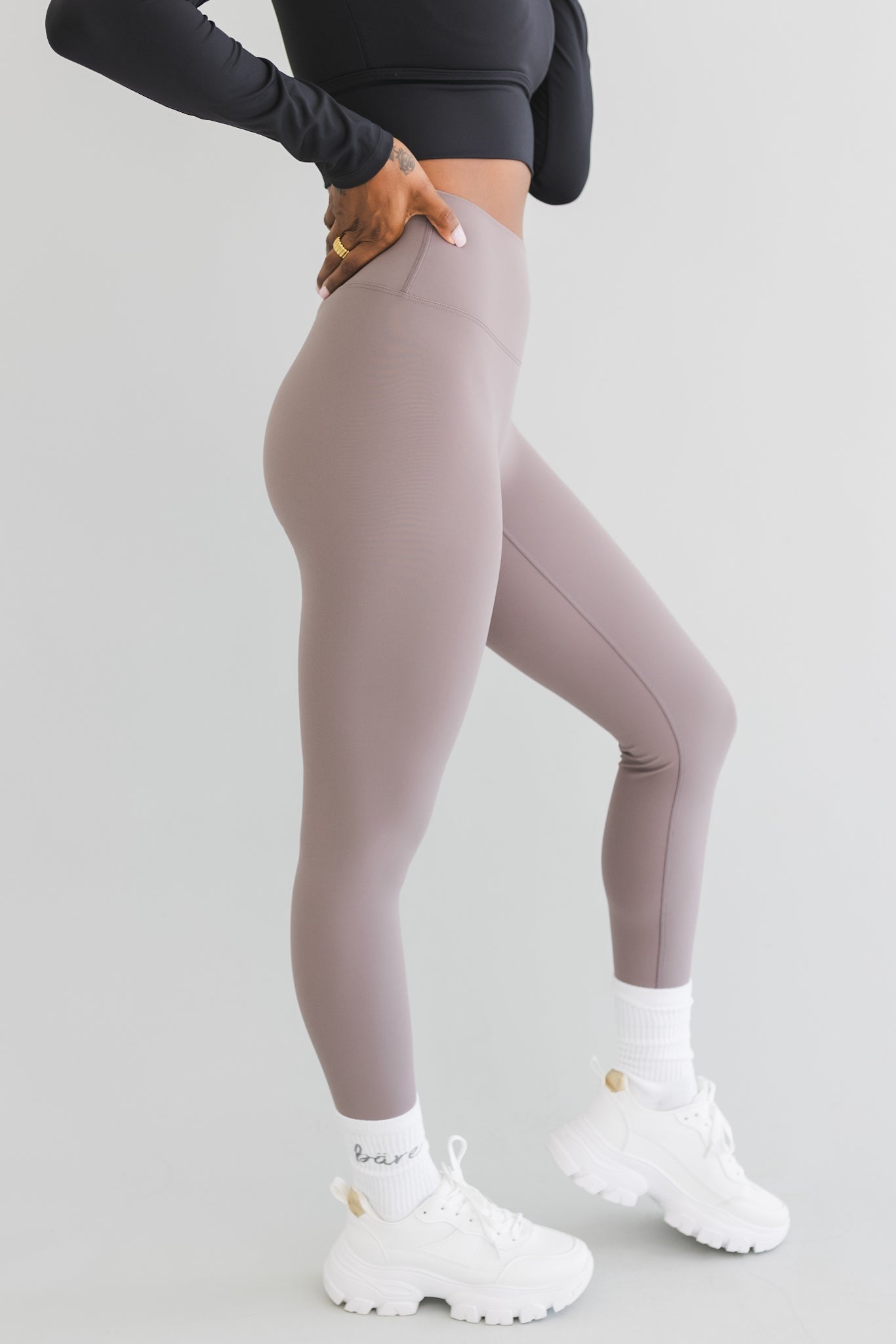 side view of a woman wearing 25 inch barely there leggings in steel grey for loungewear and athletic wear
