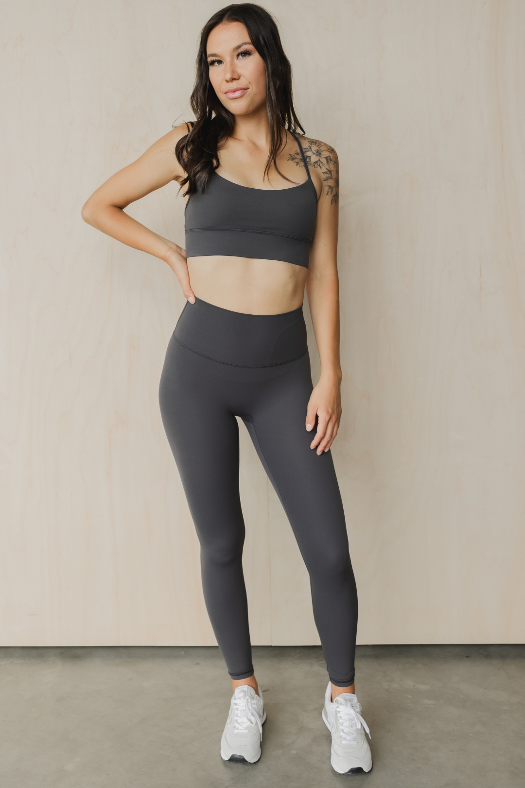 front view of a woman wearing 27 inch tall barely there leggings in dark slate grey for yoga and studio workouts