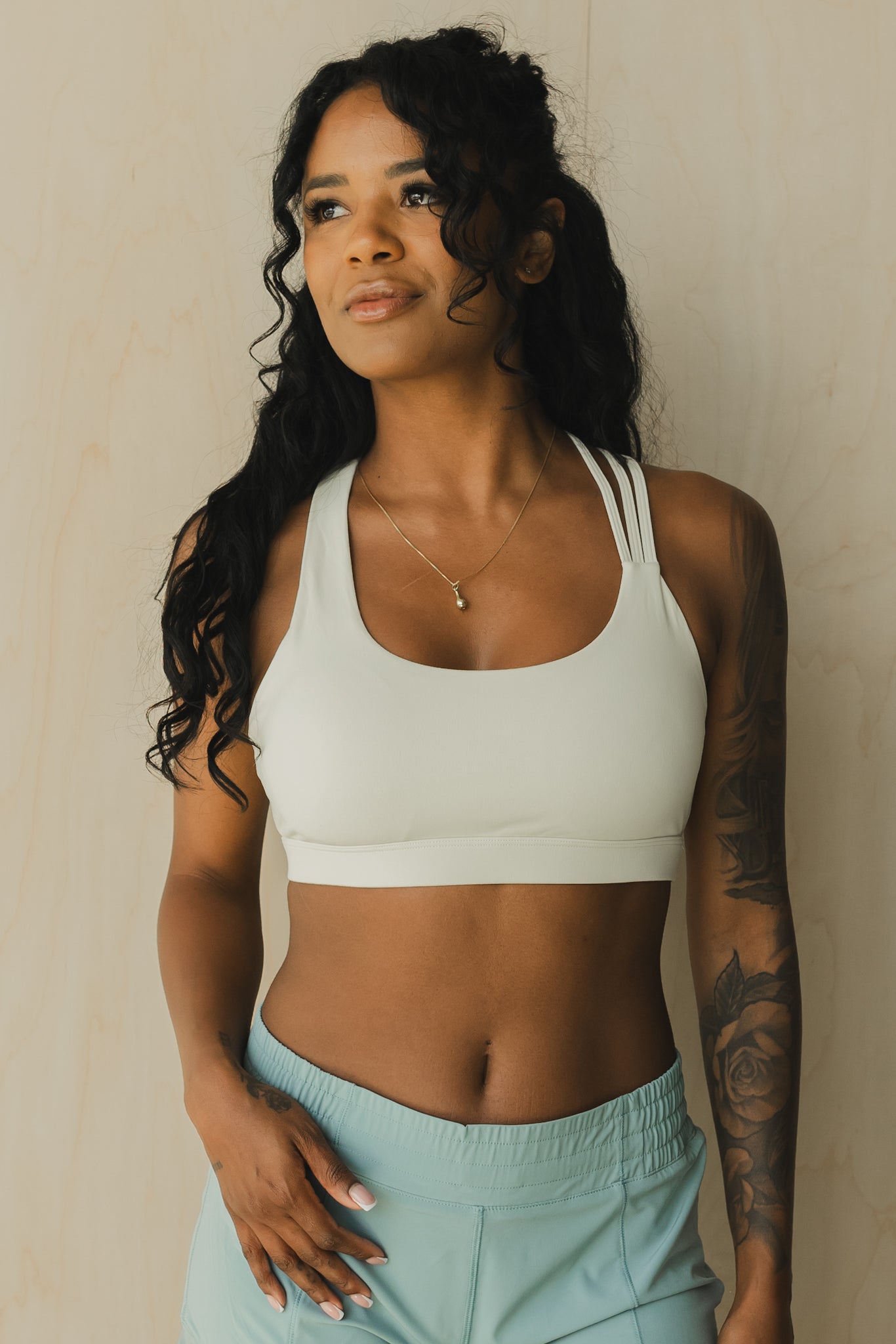 front view of a woman wearing S.F. V3 sports bra in off white for pilates and low impact training