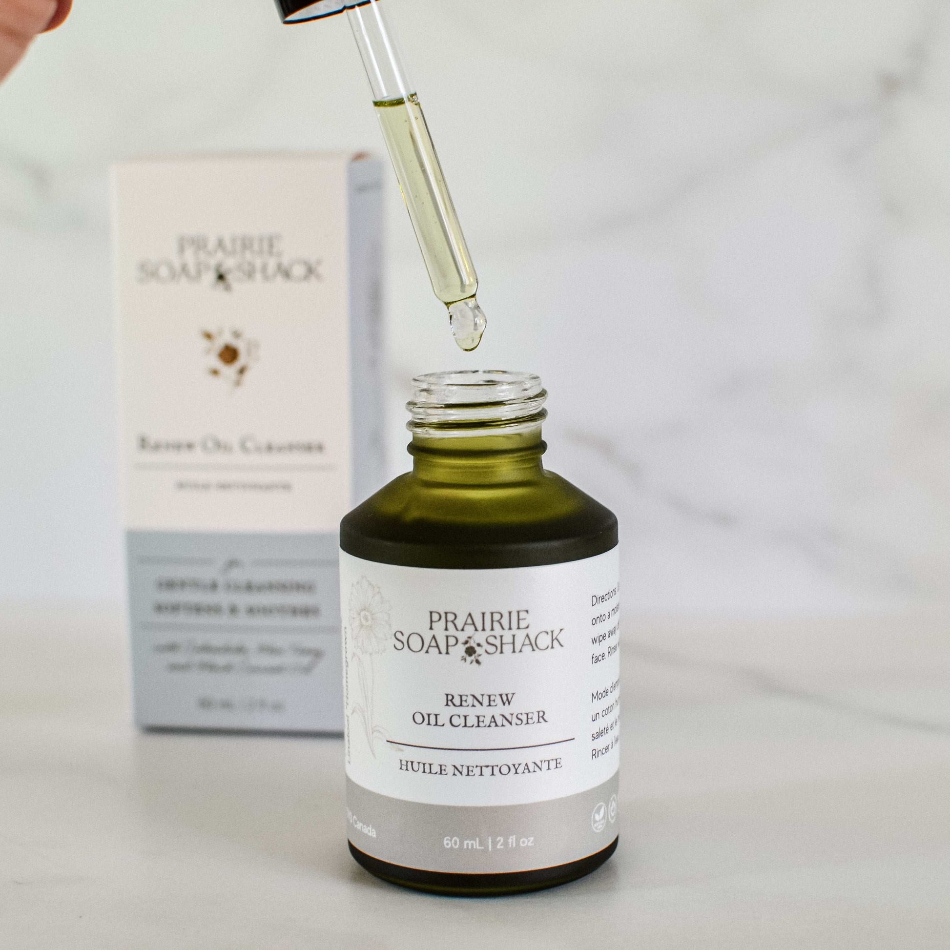 Natural calendula and blue tansy oil cleanser close-up showing bottle and dropper