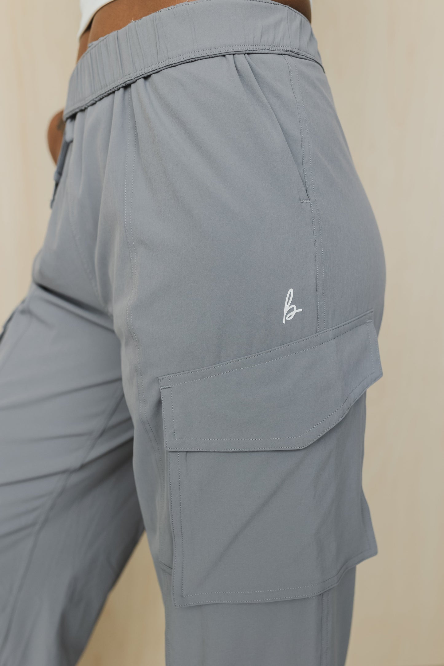 zoomed in side view of a woman wearing cargo pant in grey for streetwear and casual everyday wear