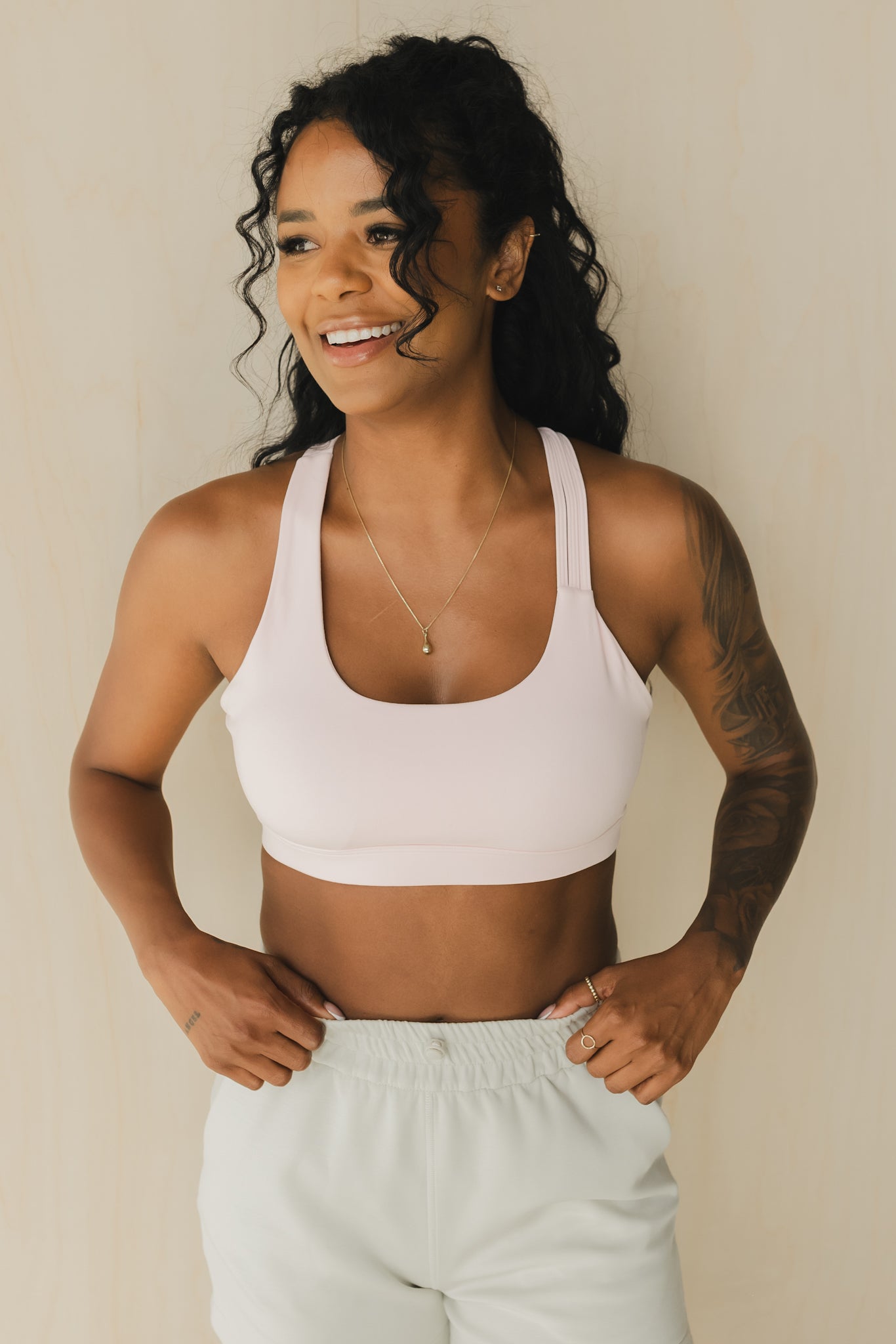 front view of a woman wearing S.F. V3 sports bra in pink lemonade for yoga and studio workouts