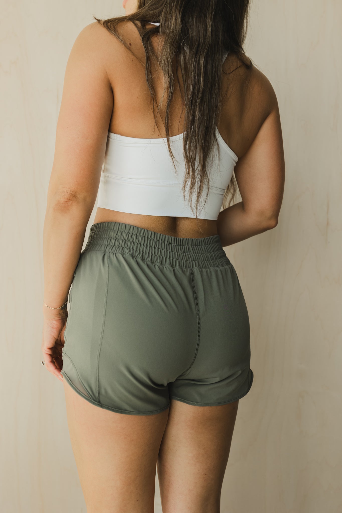 back view of woman wearing Ready for It shorts in sage for workouts and casual wear