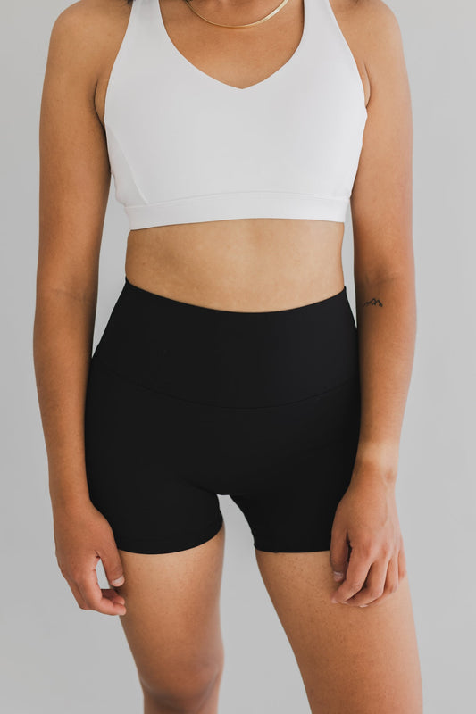 front view of woman wearing barely There 4" yoga shorts in black, lightweight squat-proof activewear