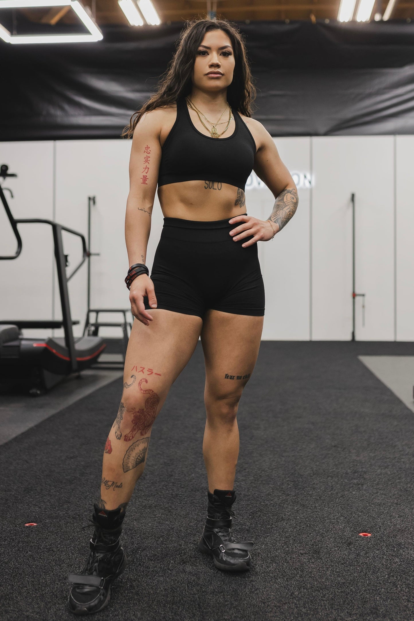 front view of a woman wearing mini scrunch shorts in black for yoga and summer activewear