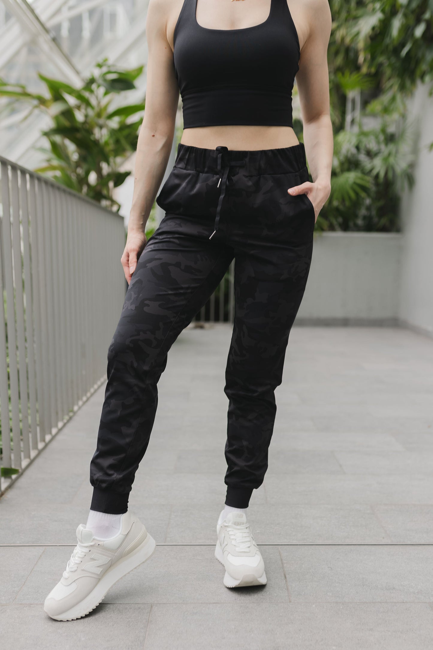 front view of a woman wearing cuffed ankle jogger in black camo for streetwear and everyday wear