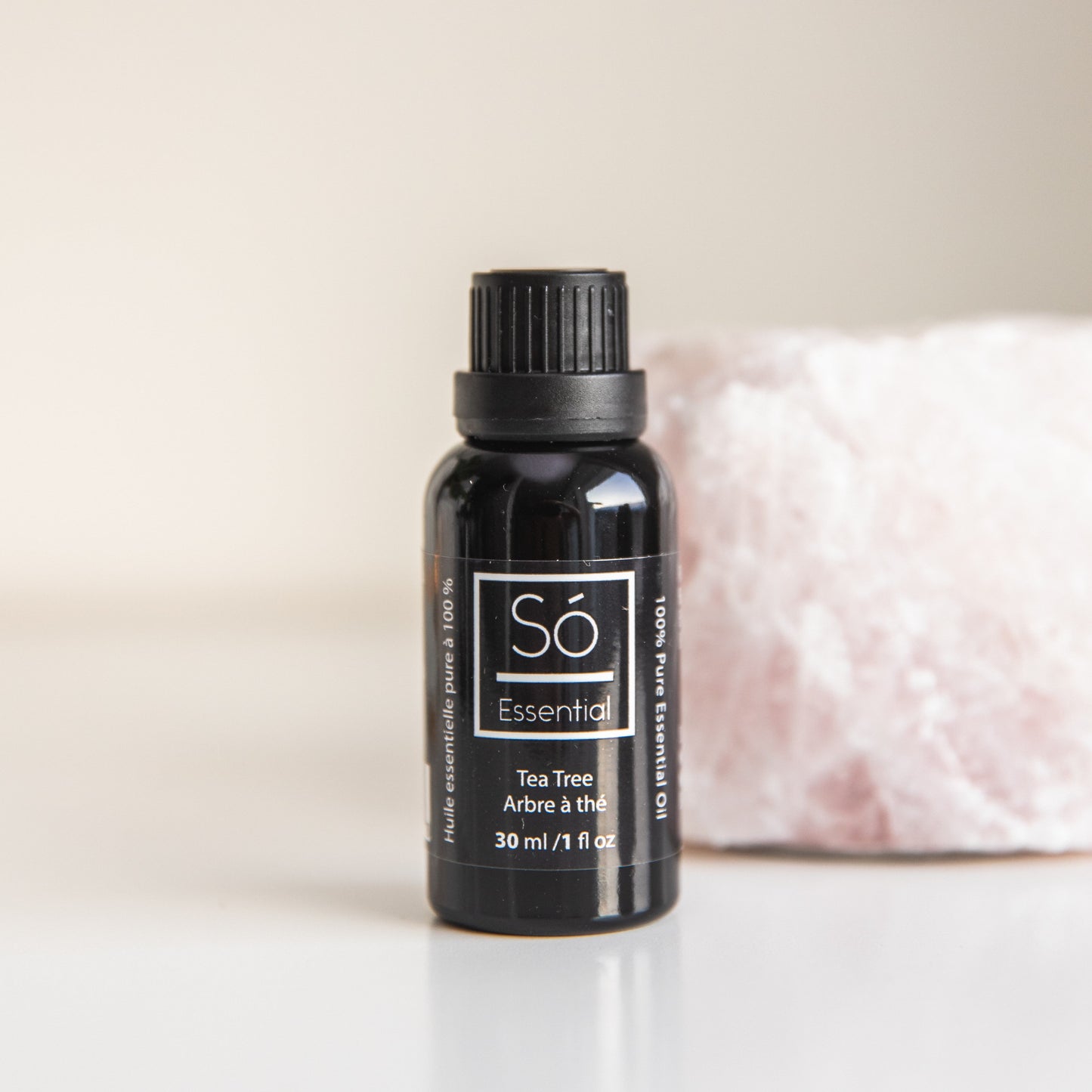 Black Tea Tree essential oil bottle labeled 'Sö Essential' on a light background