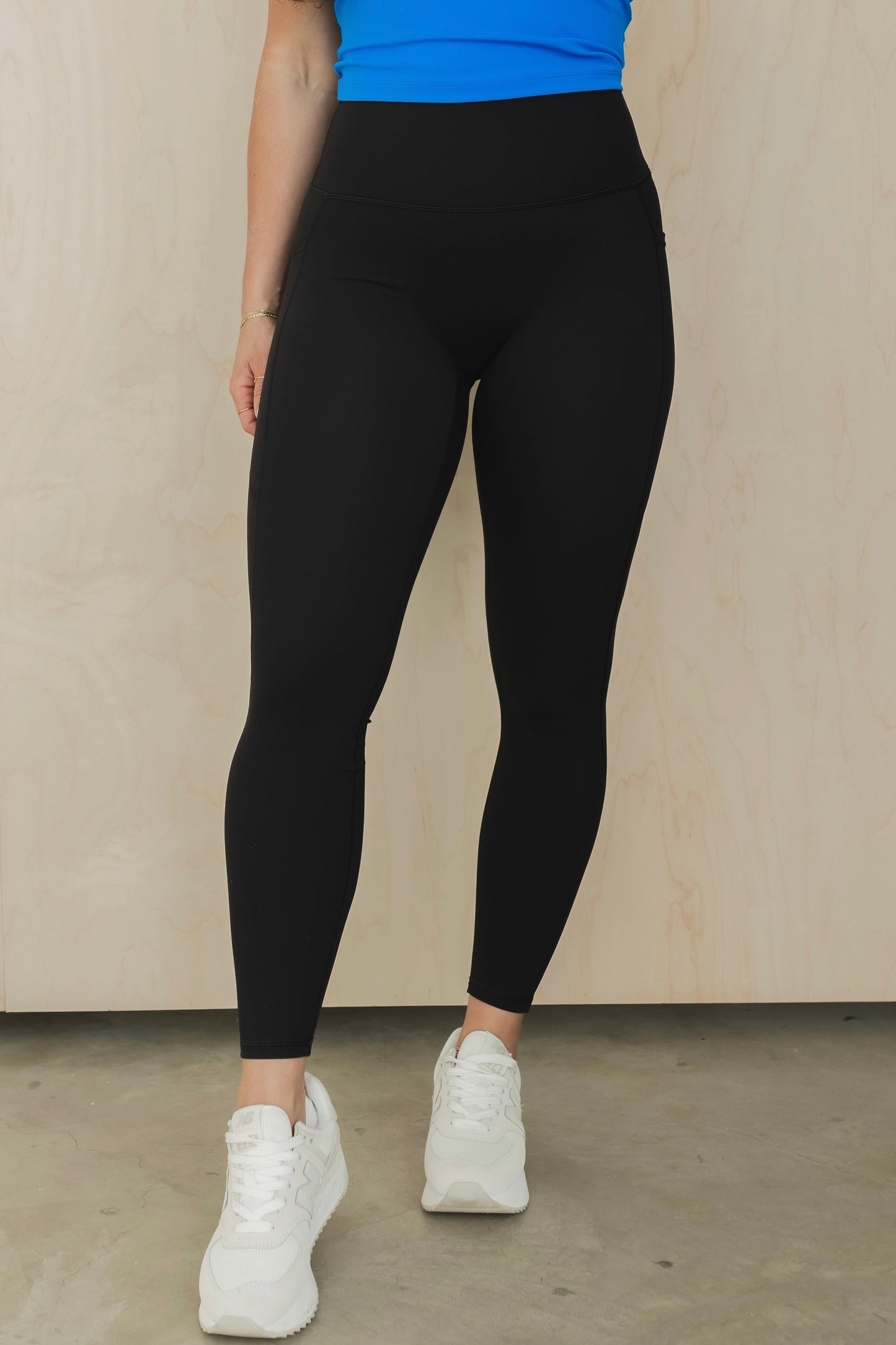 zoomed in view of a woman wearing the unmatched pant in black for the gym and everyday activewear