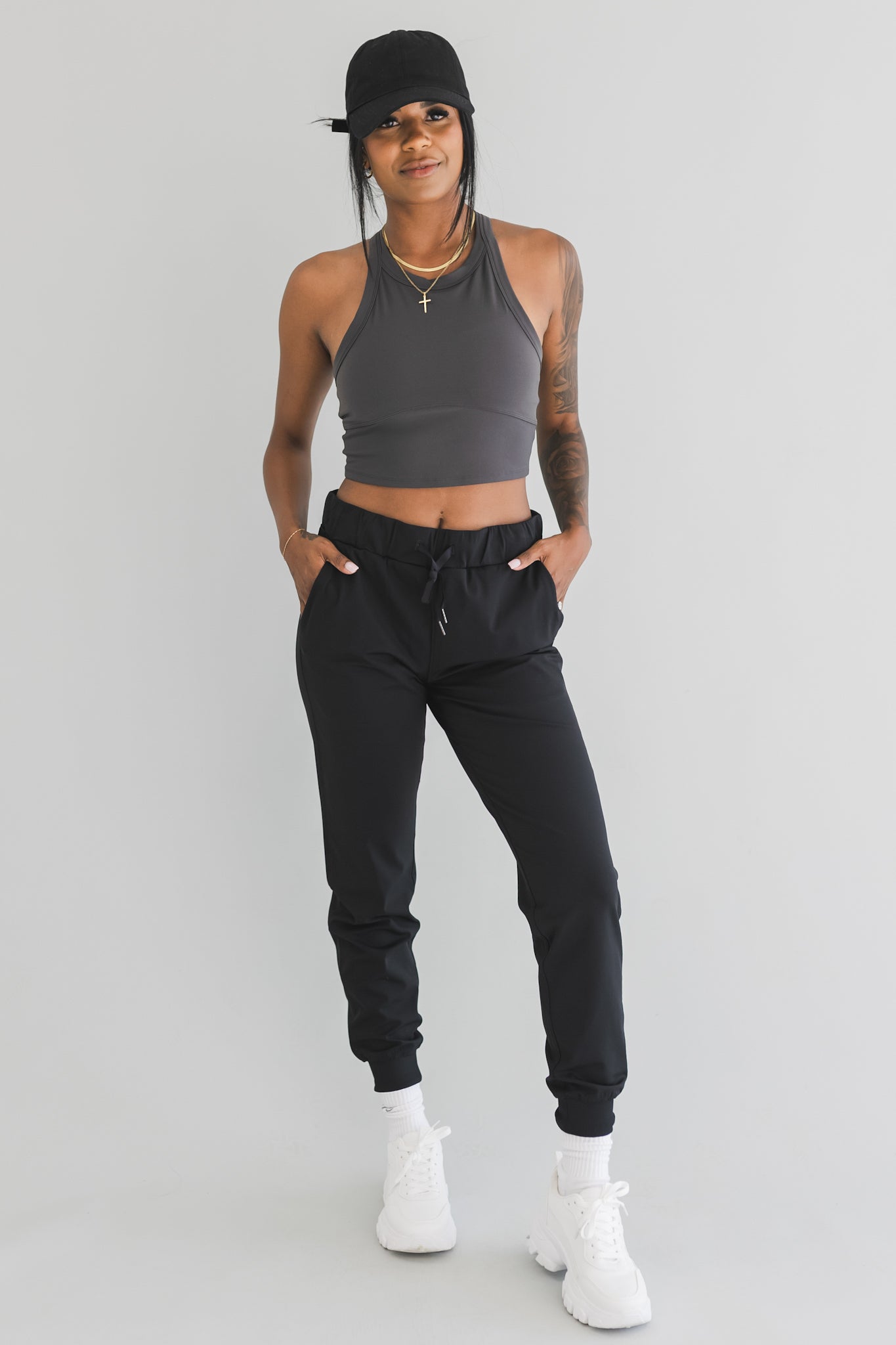 full front view of a woman wearing cuffed ankle jogger in black camo for streetwear and everyday wear