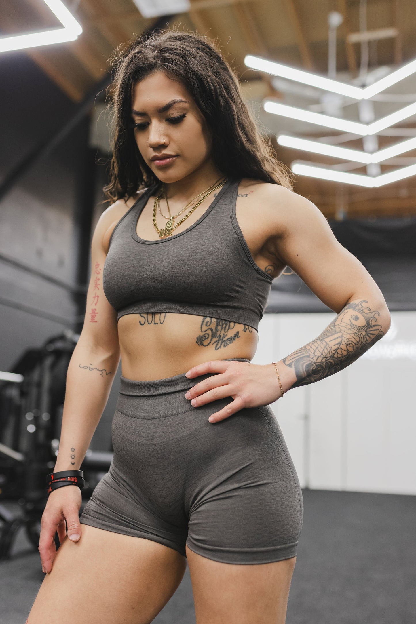 front view of a woman wearing mini scrunch shorts in dark grey for yoga and summer activewear