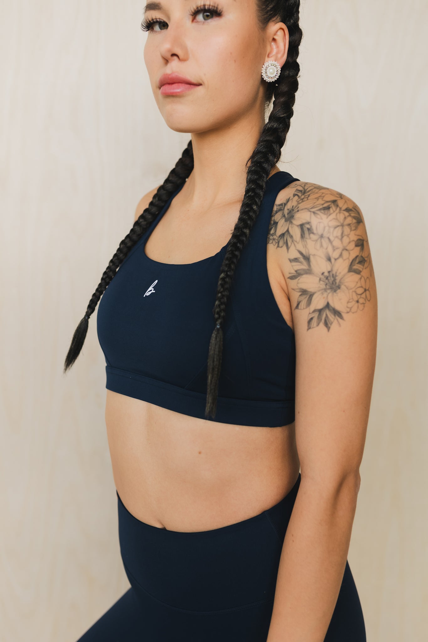 side view of a woman wearing a Fight or Flight high-support sports bra in midnight blue for yoga and fitness