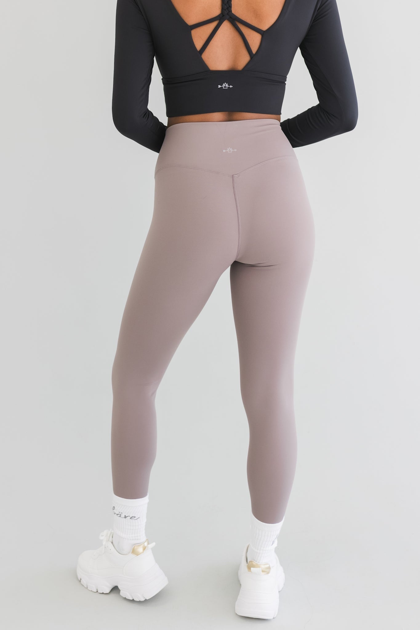 back view of a woman wearing 25 inch barely there leggings in steel grey for loungewear and athletic wear