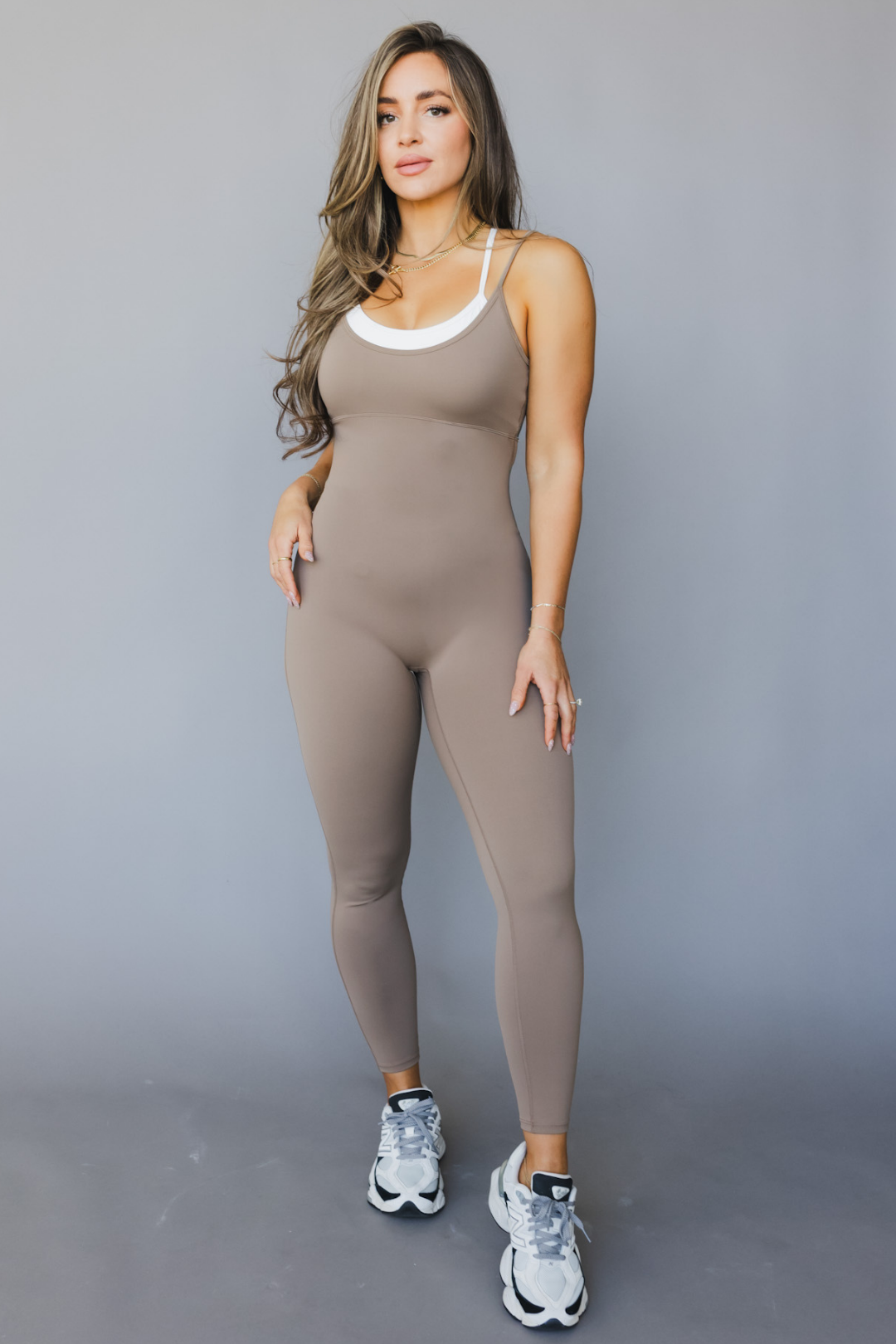 front view of a woman wearing tina bodysuit in sable brown for pilates and everyday styling