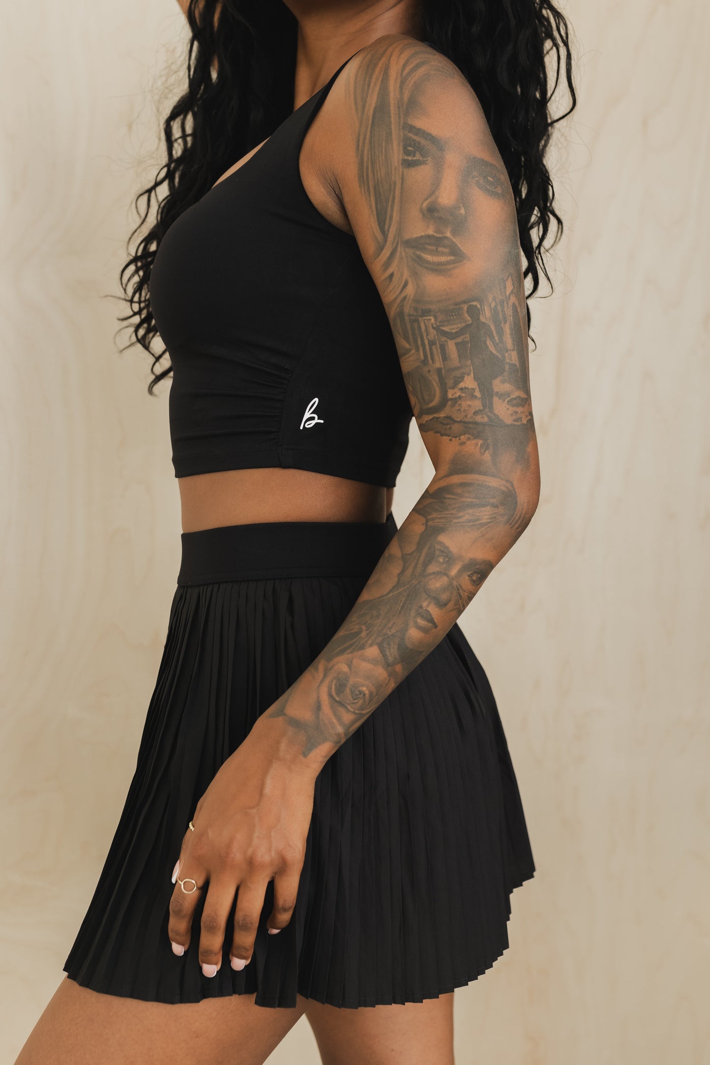 side view of a woman wearing a sweetheart tank top in black for yoga and activewear
