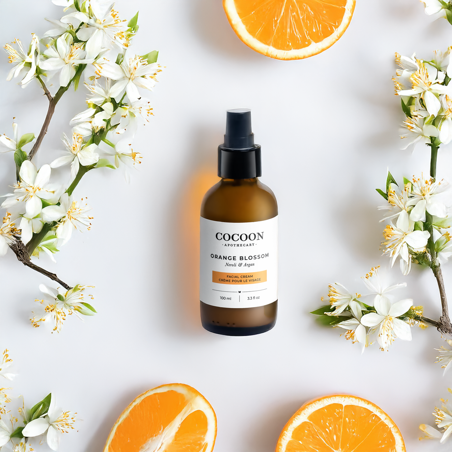 face cream skincare bottle with orange blossoms and oranges on a light background
