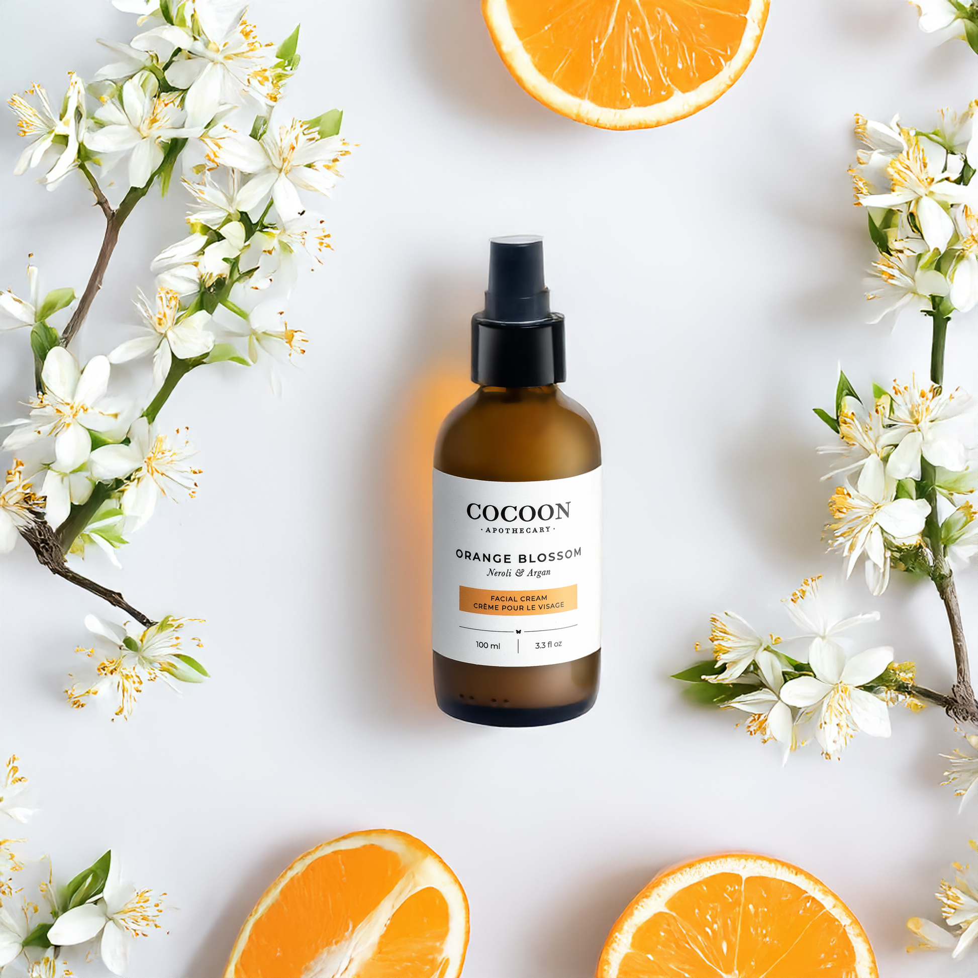 face cream skincare bottle with orange blossoms and oranges on a light background