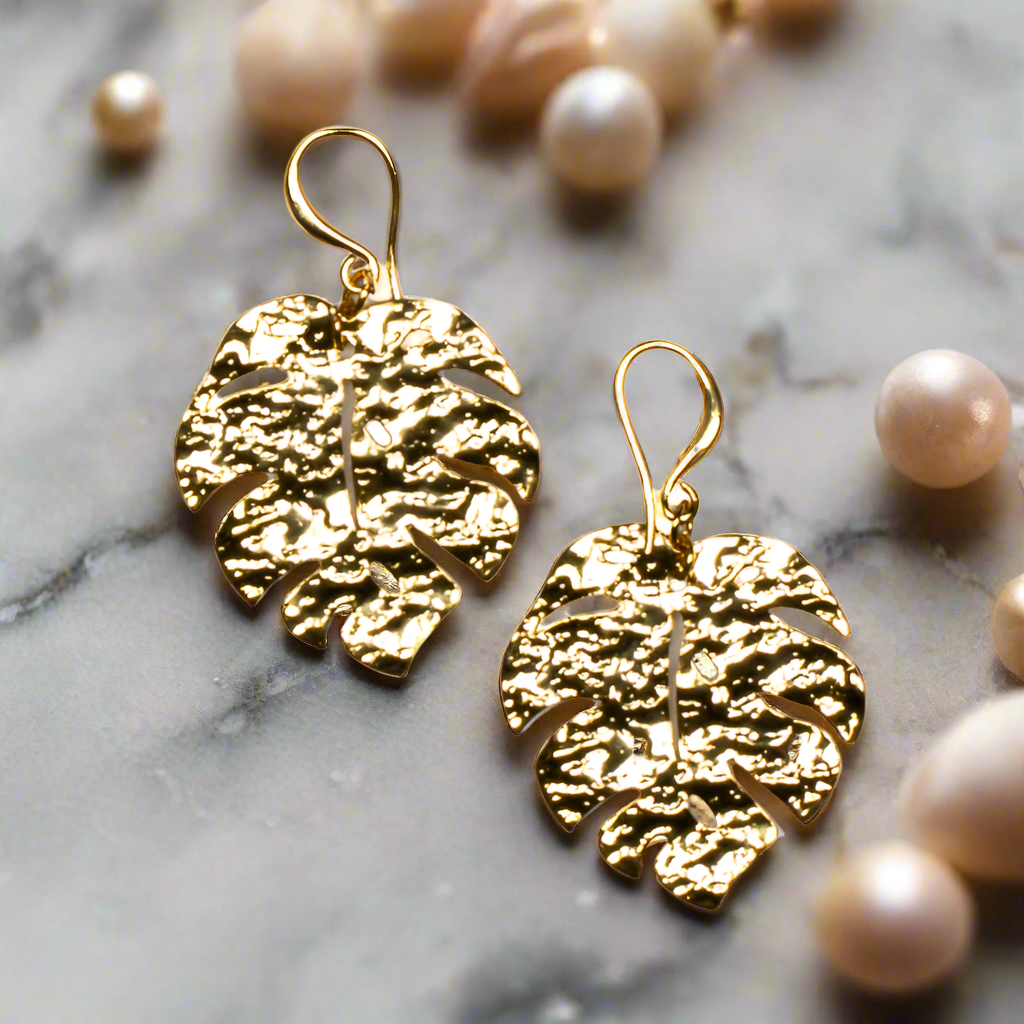 Gold plate hammered leaf drop earrings nature boho jewelry handmade in Bali up close view