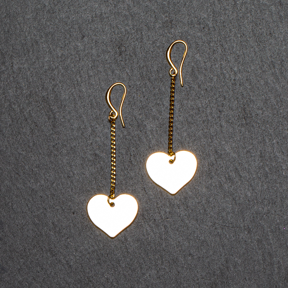 Gold plate drop chain heart earrings dangle romantic jewelry on dark background