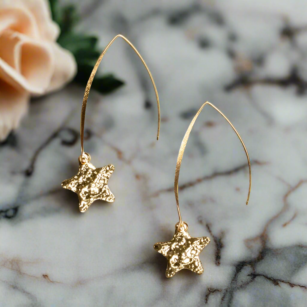 Gold plate hammered star drop earrings celestial up close artisan jewelry handmade in Bali