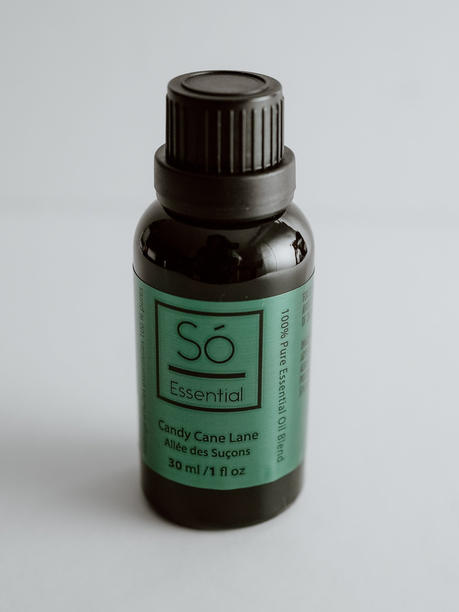 Candy Cane Essential oil bottle labeled 'Sö Essential' on a gray background