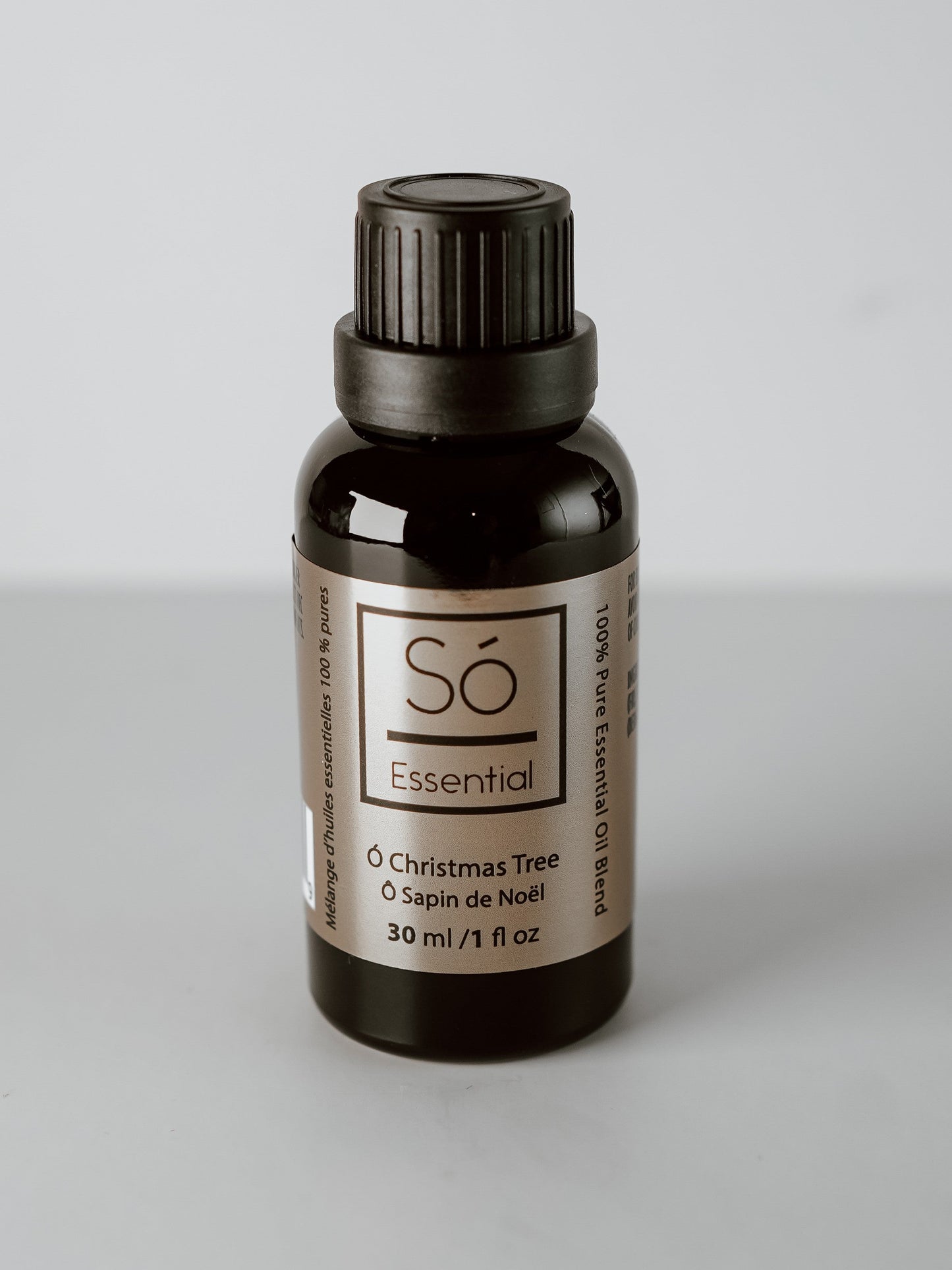 Christmas Essential oil bottle labeled 'Sö Essential' on a gray background