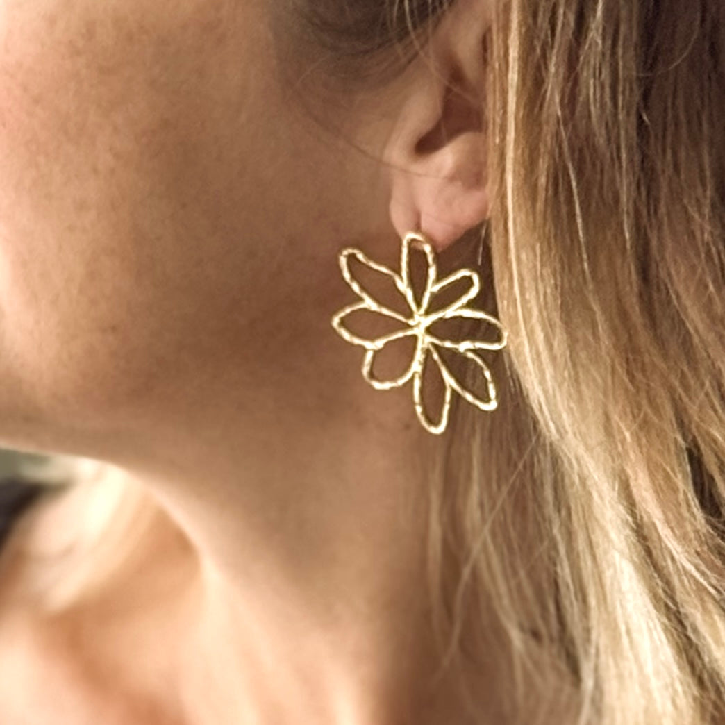 Open flower stud earrings in woman's ear boho floral artisan jewelry handmade in Bali 