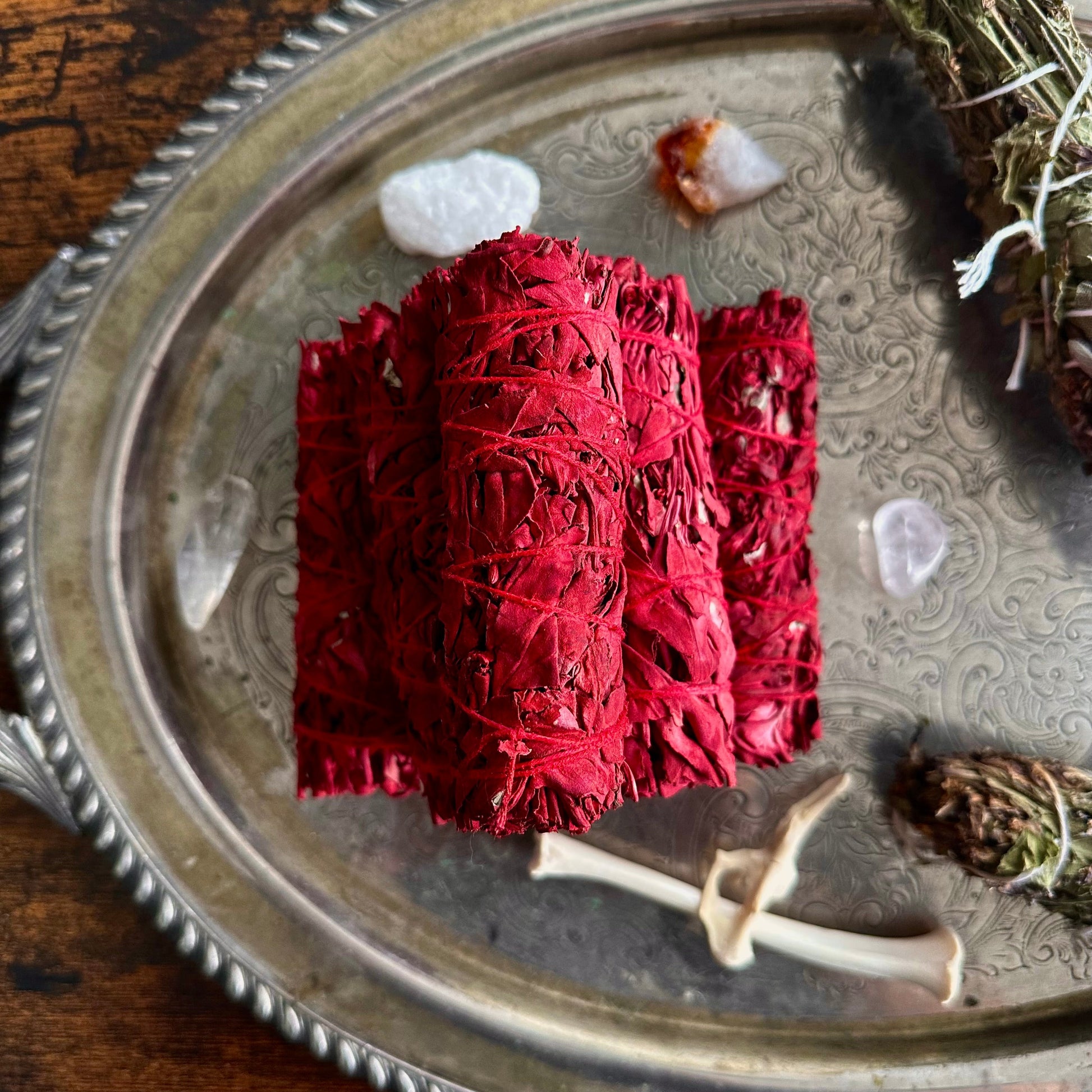 Red safe incense on a silver tray with natural elements