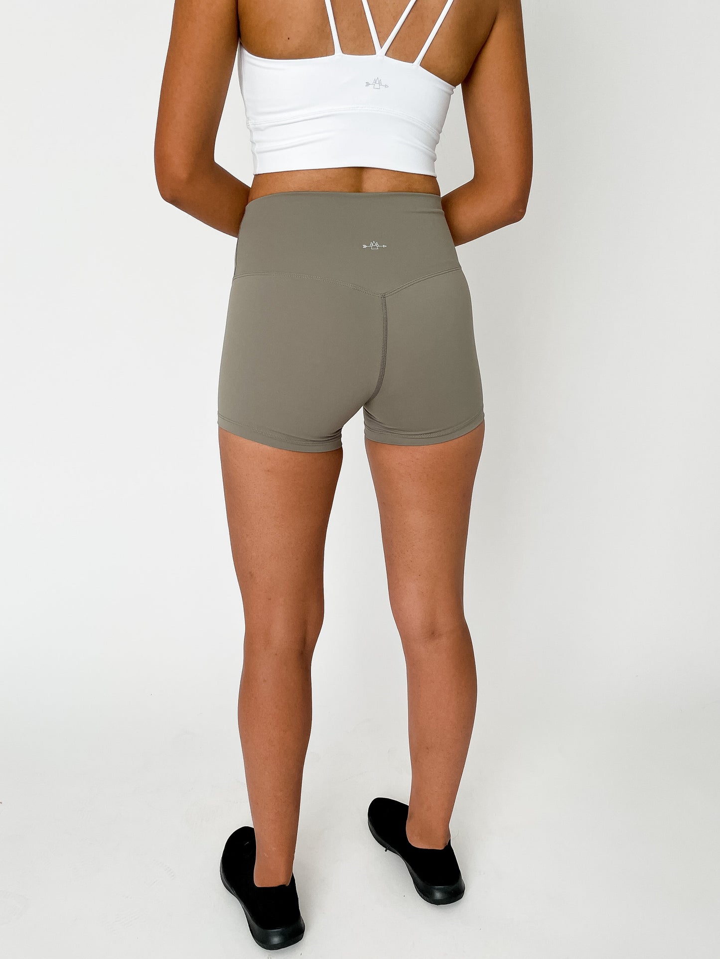 back view of woman wearing barely There 4" yoga shorts in bronzed green, lightweight squat-proof activewear