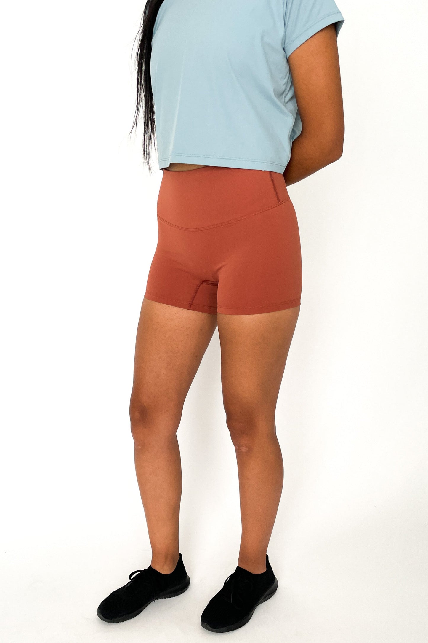 front view of woman wearing barely There 4" yoga shorts in burnt orange, lightweight squat-proof activewear
