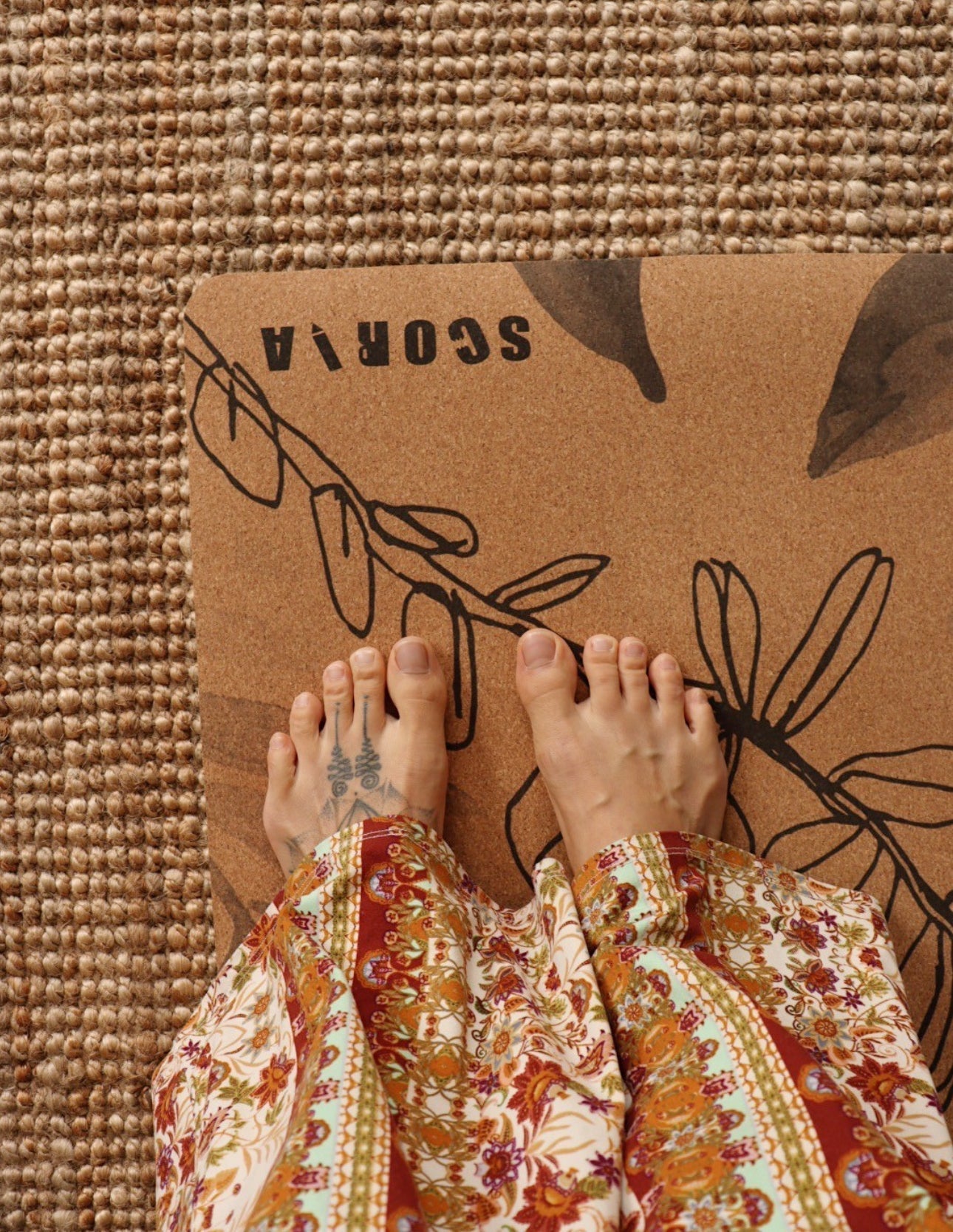 womans feet on cork yoga mat with botanicals design