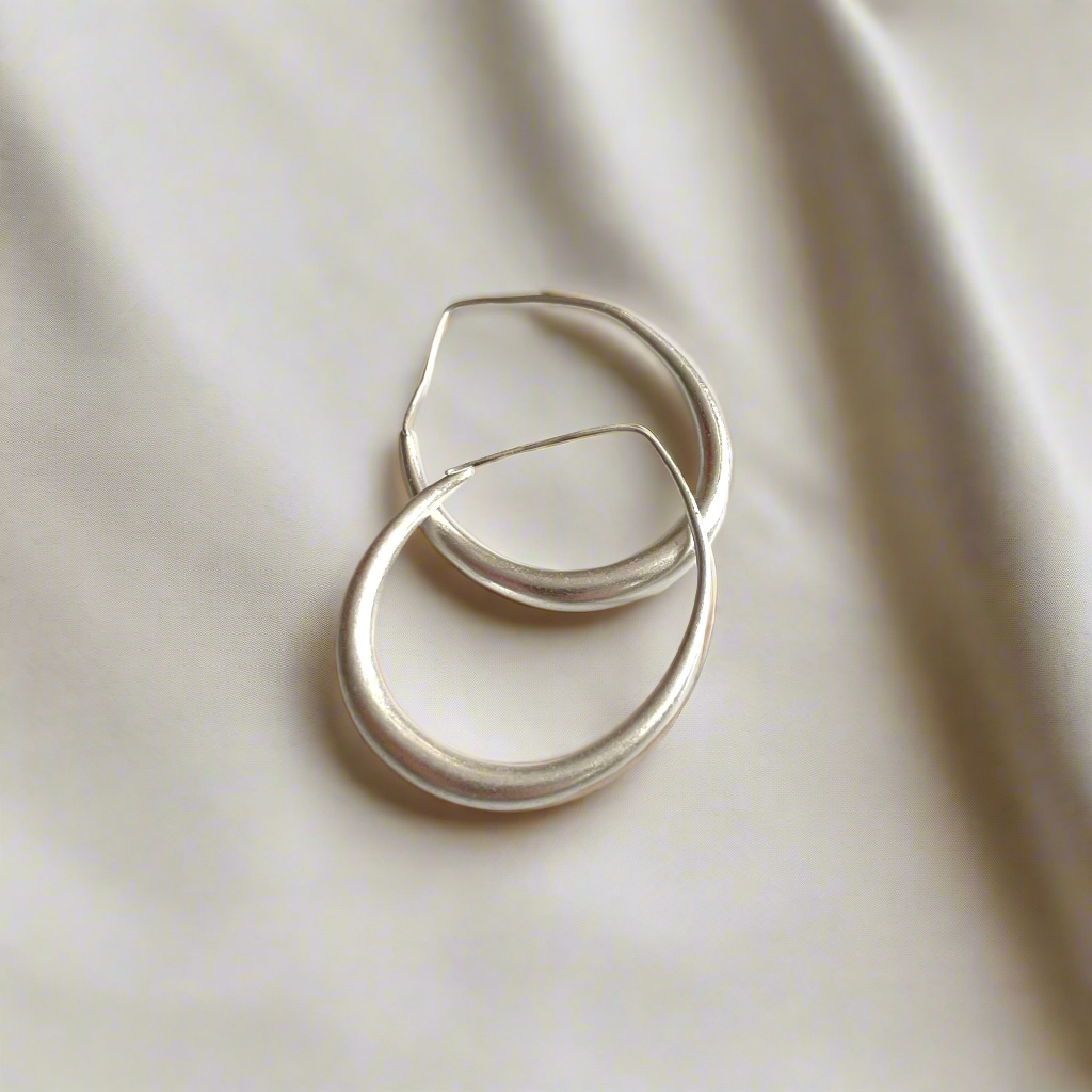 Silver plate teardrop hoop earrings elegant dangle jewelry stacked on top of each other