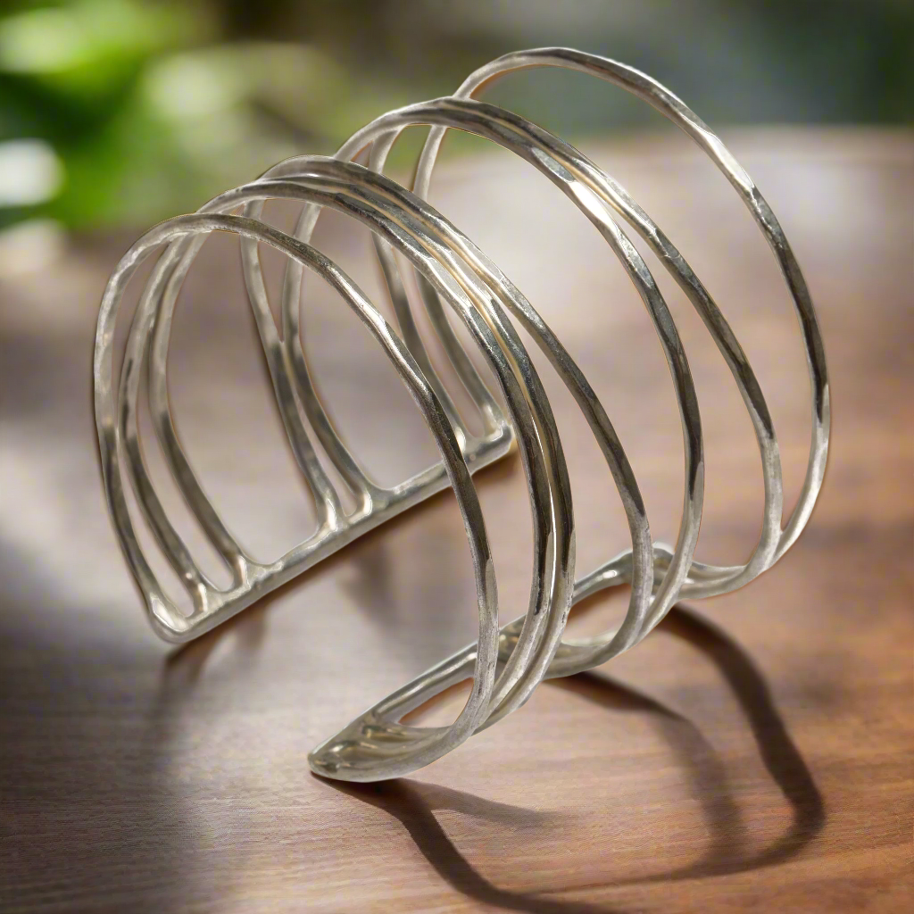 Silver metal toast rack on a wooden surface with a blurred natural background
