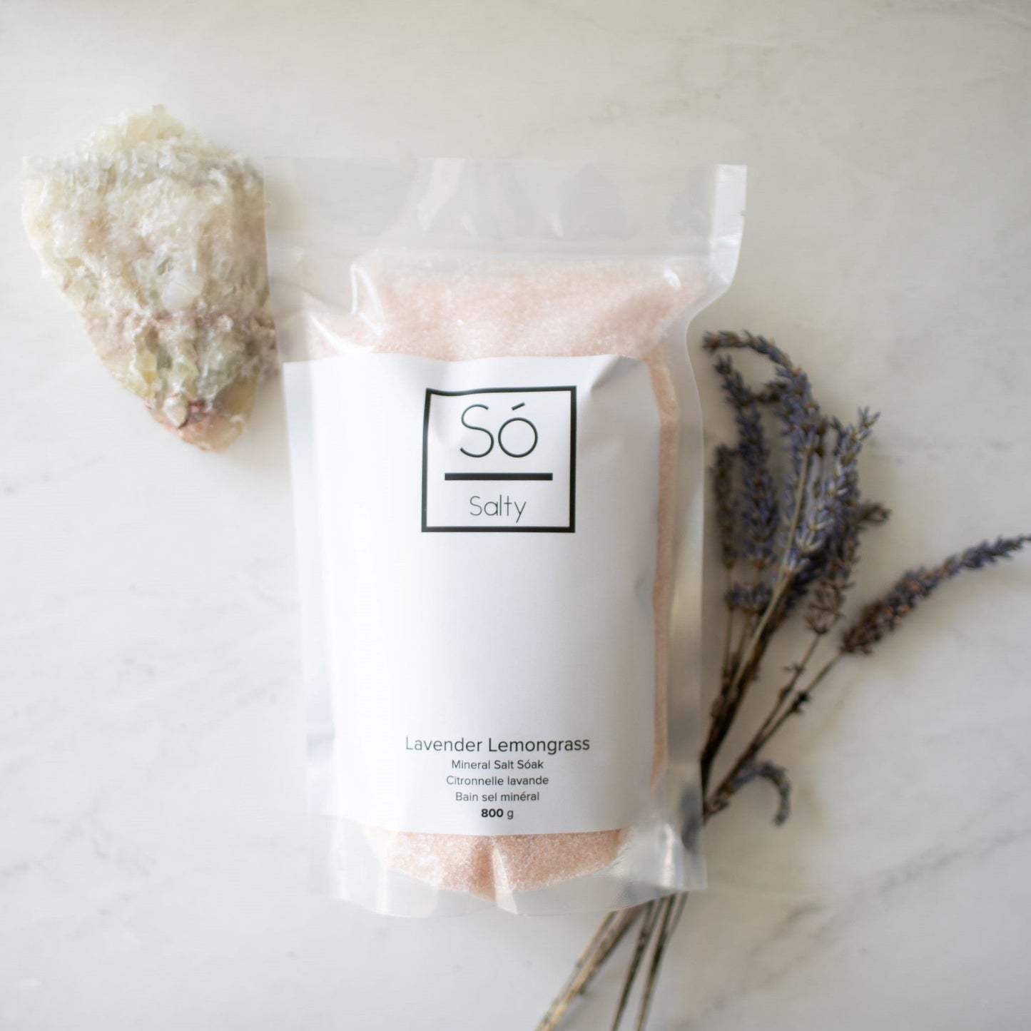 Packaged Só Salty Bath Salts with decorative elements on a light background