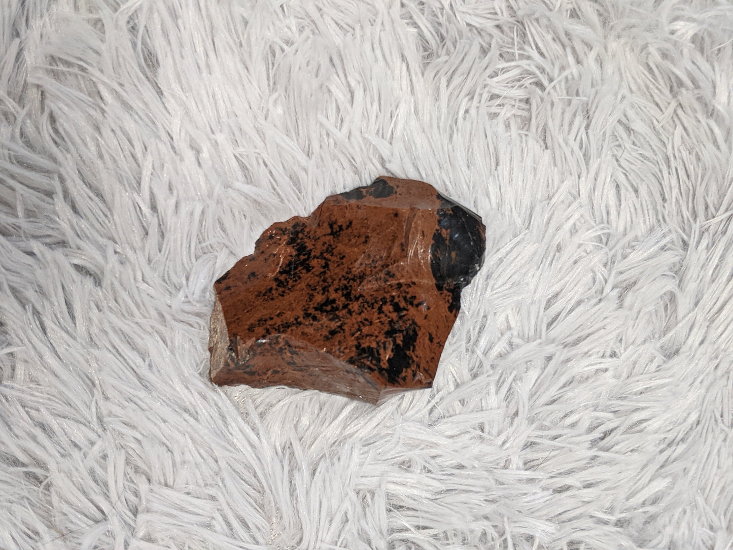 Mahogany obsidian close-up showing natural red and black volcanic stone detail