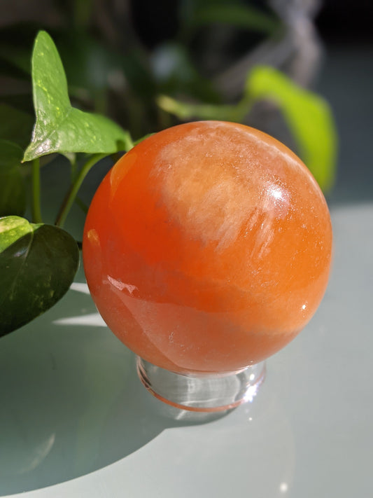 Uplifting and creativity-boosting orange calcite sphere for joy and sacral chakra healing