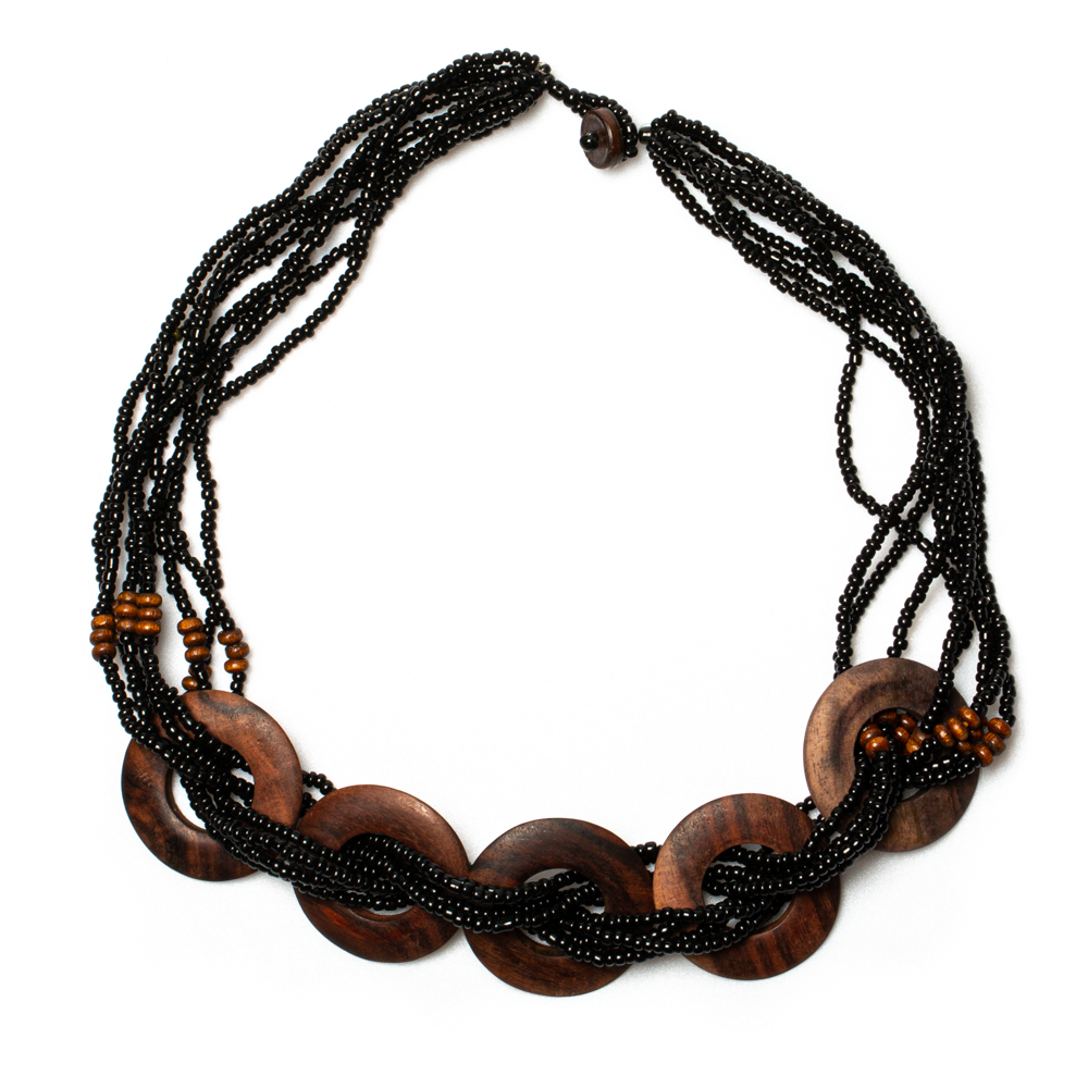 Necklace with wooden links and black beads on a white background