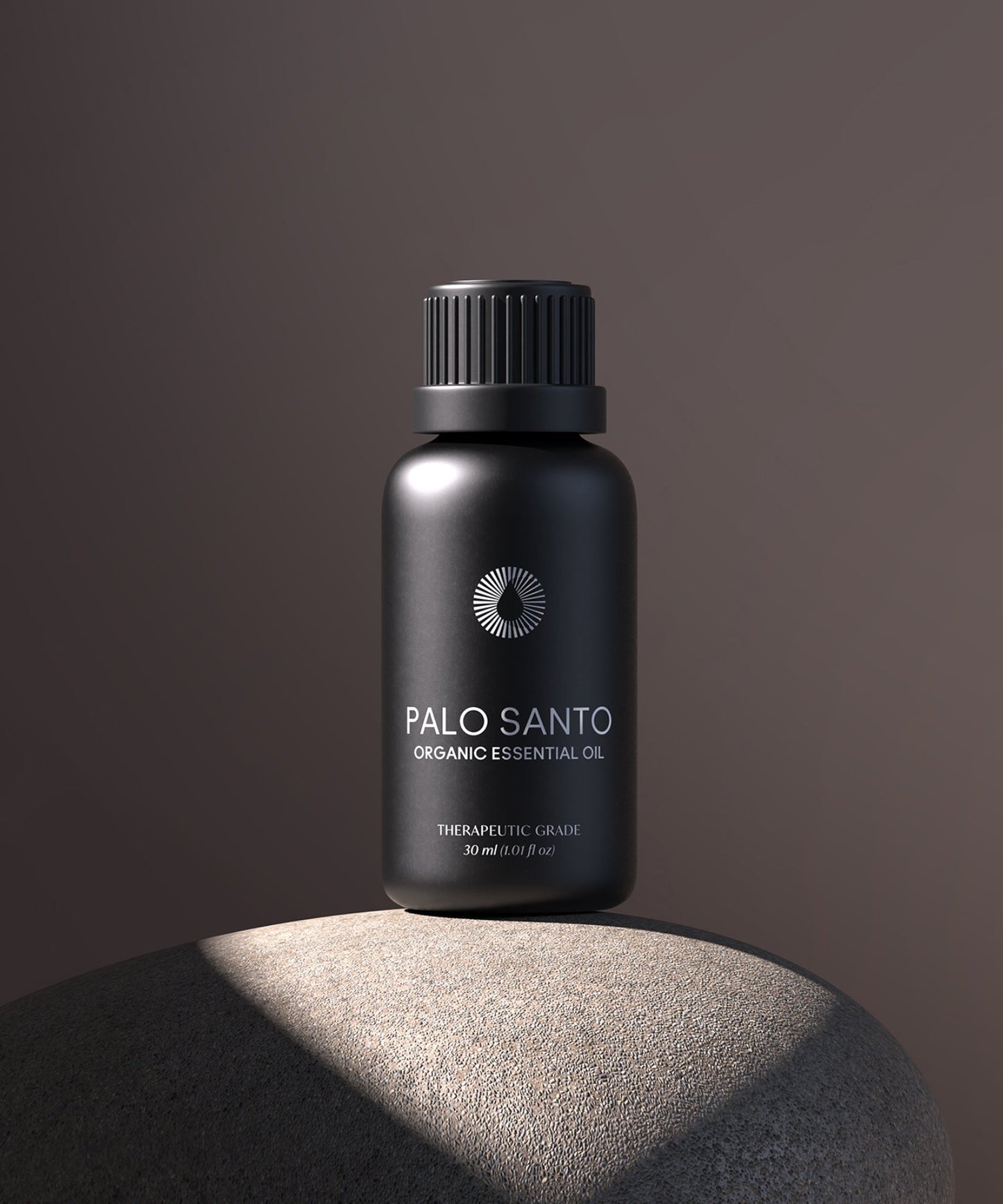 large bottle of Palo Santo organic essential oil on a dark background